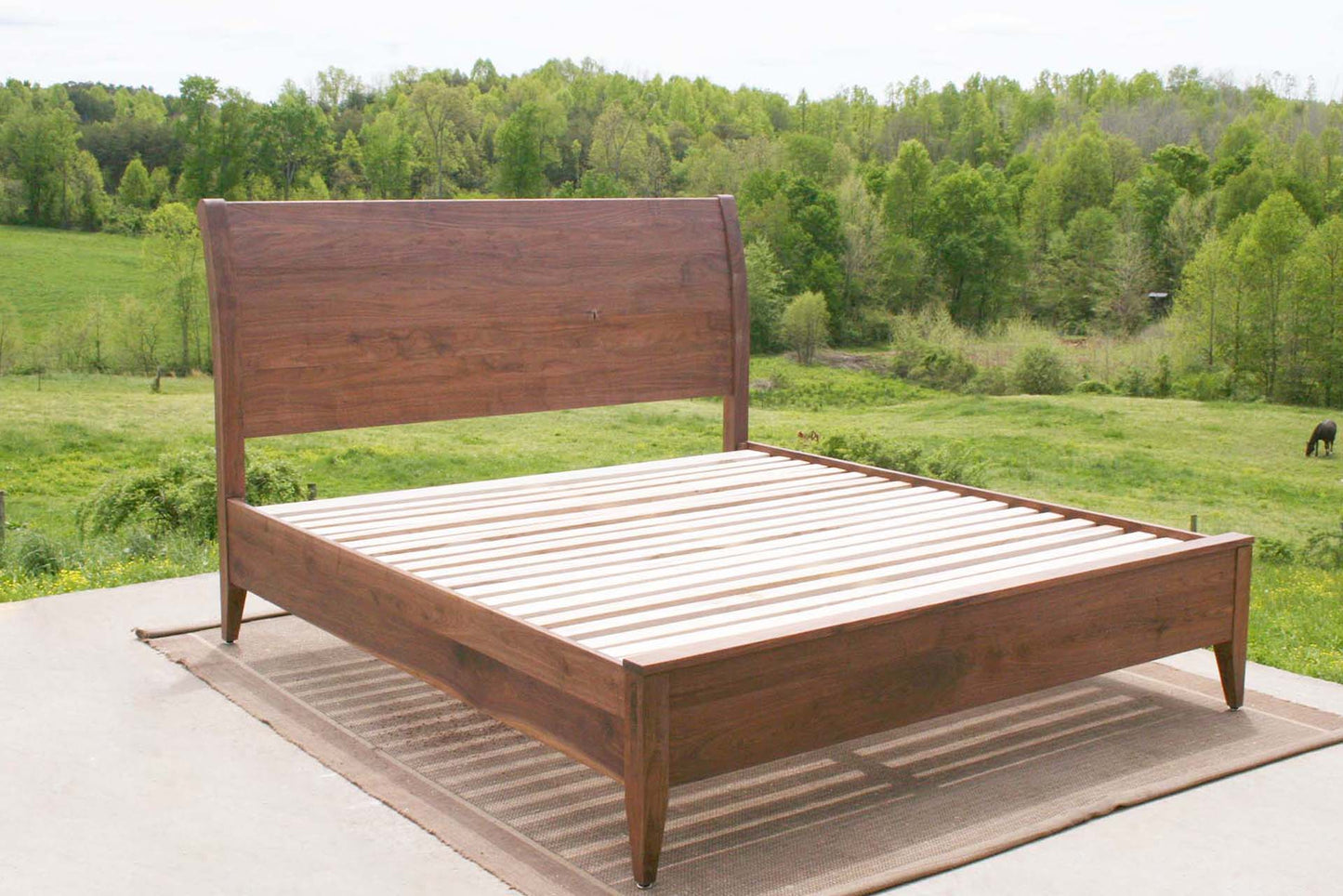 angled view walnut sleigh bed