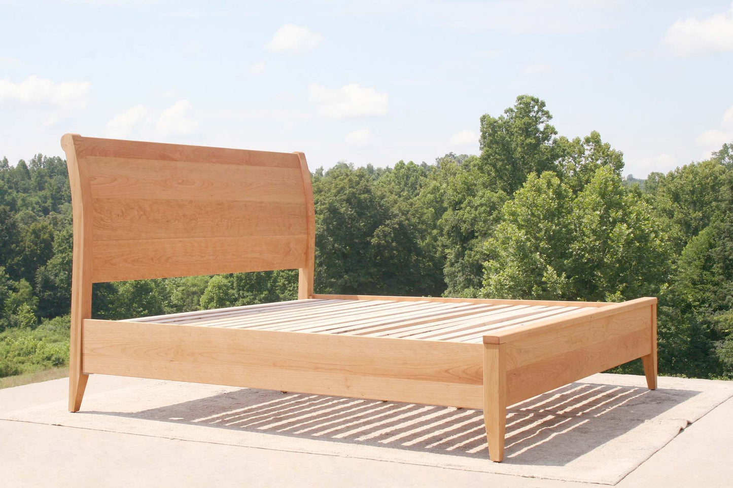 low angled view cherry sleigh bed