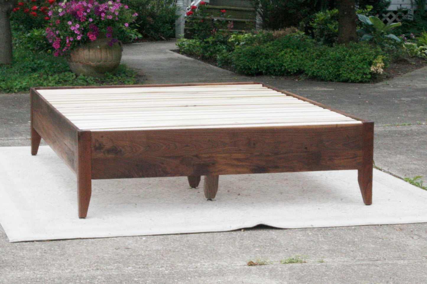 front view walnut storage bed with 6 drawers and angled headboard