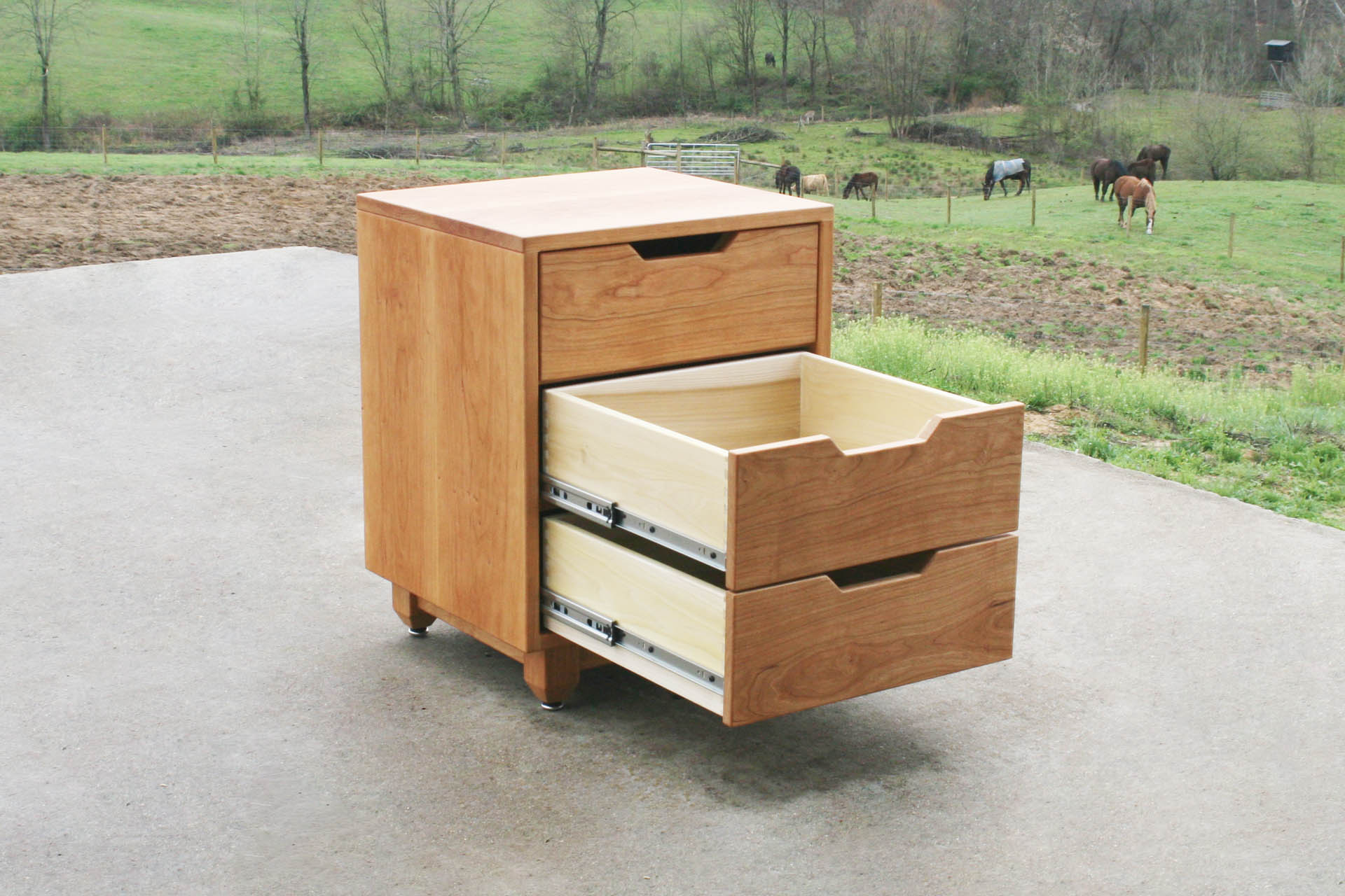 Three drawer nightstand with lower drawers open