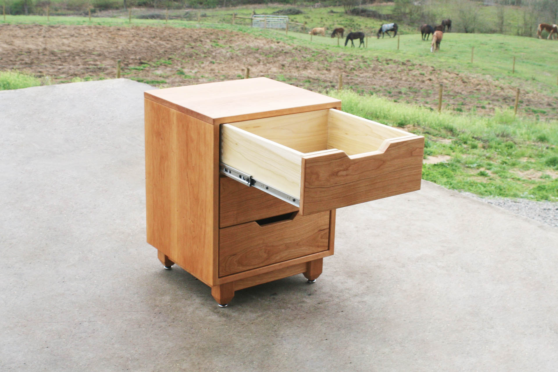 Three drawer nightstand with upper drawer open