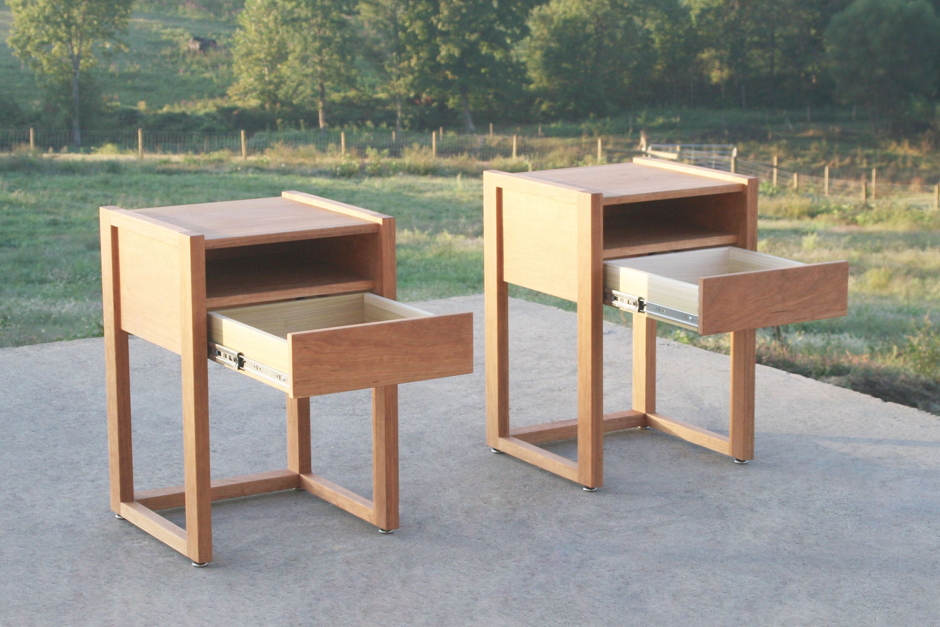 solid hardwood nightstand with shelves and open drawers angled view