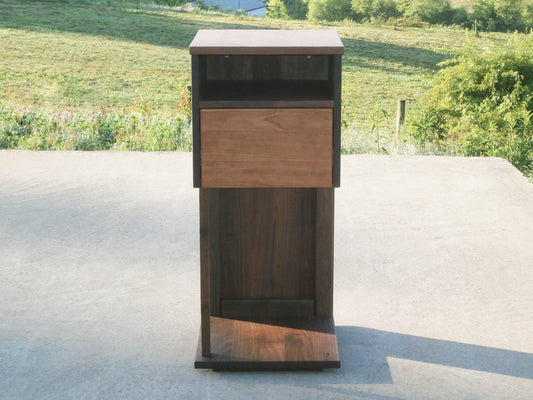 Overhanging table with drawer, shelf and support bar front view