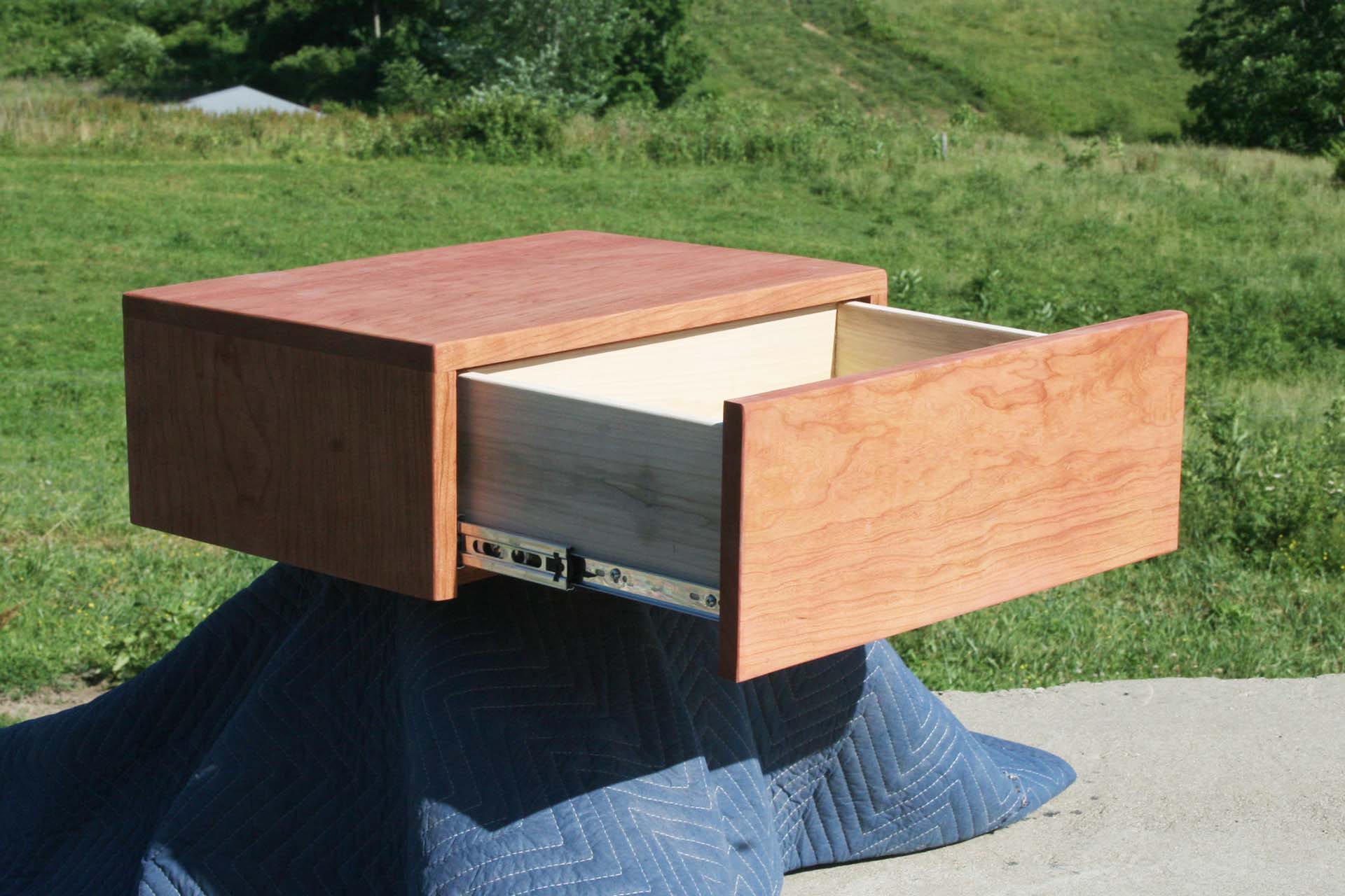 angled view floating nightstand drawer open