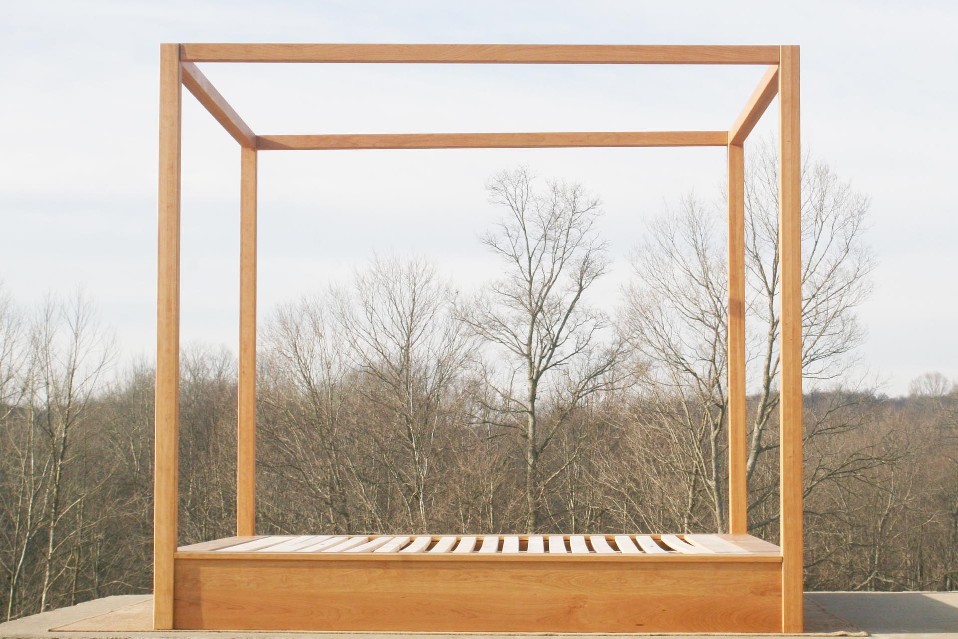 Modern canopy bed with wide platform and large rails side view