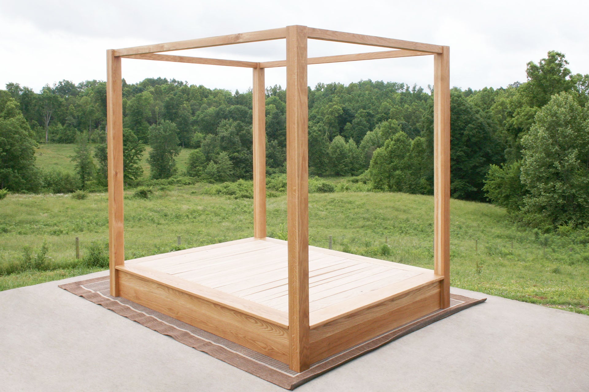 angled view Low Platform Bed with large posts and canopy