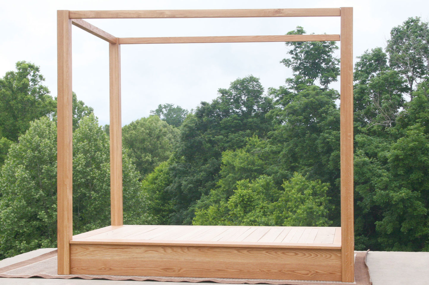 side view natural Low Platform Bed with large posts and canopy