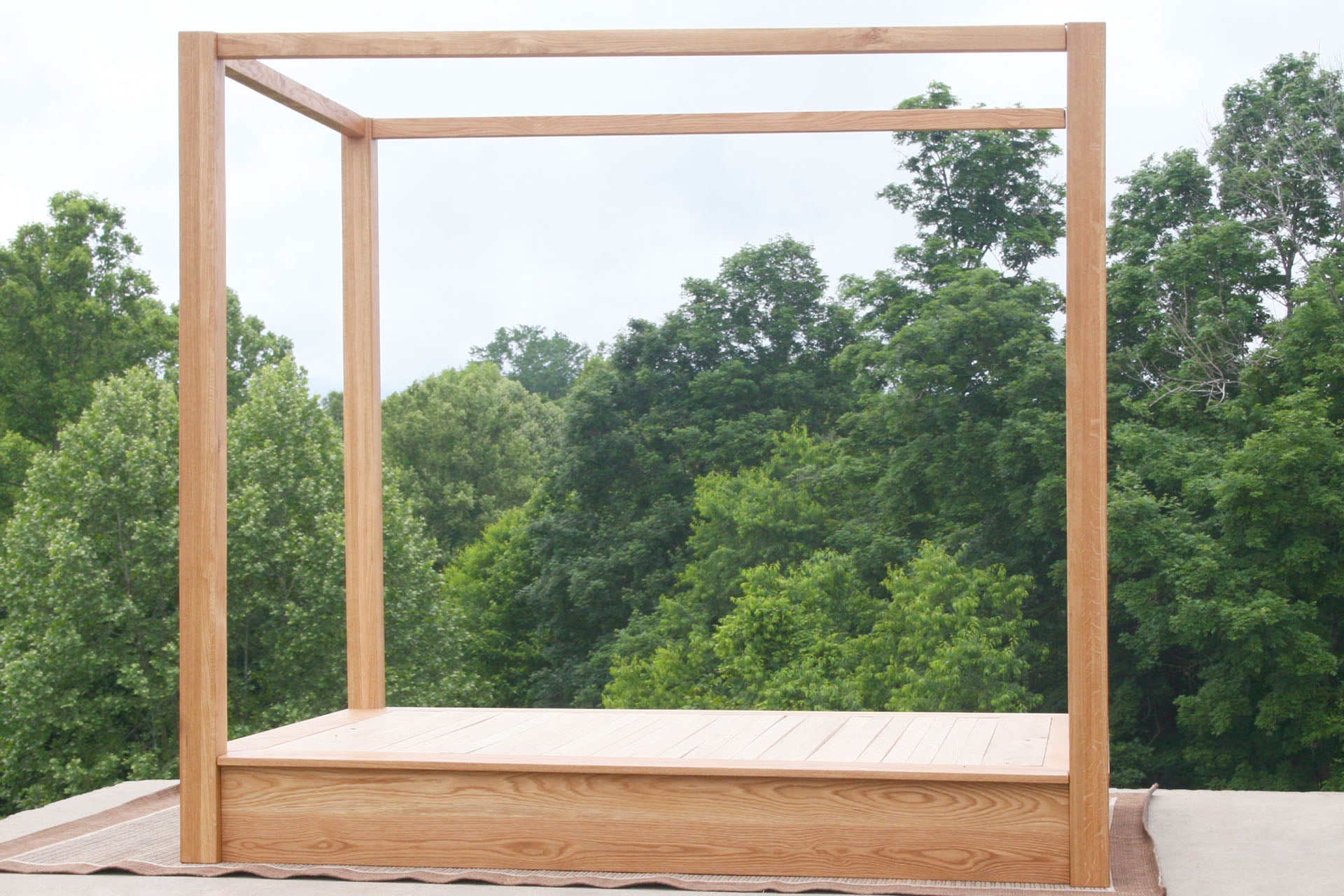side view natural Low Platform Bed with large posts and canopy