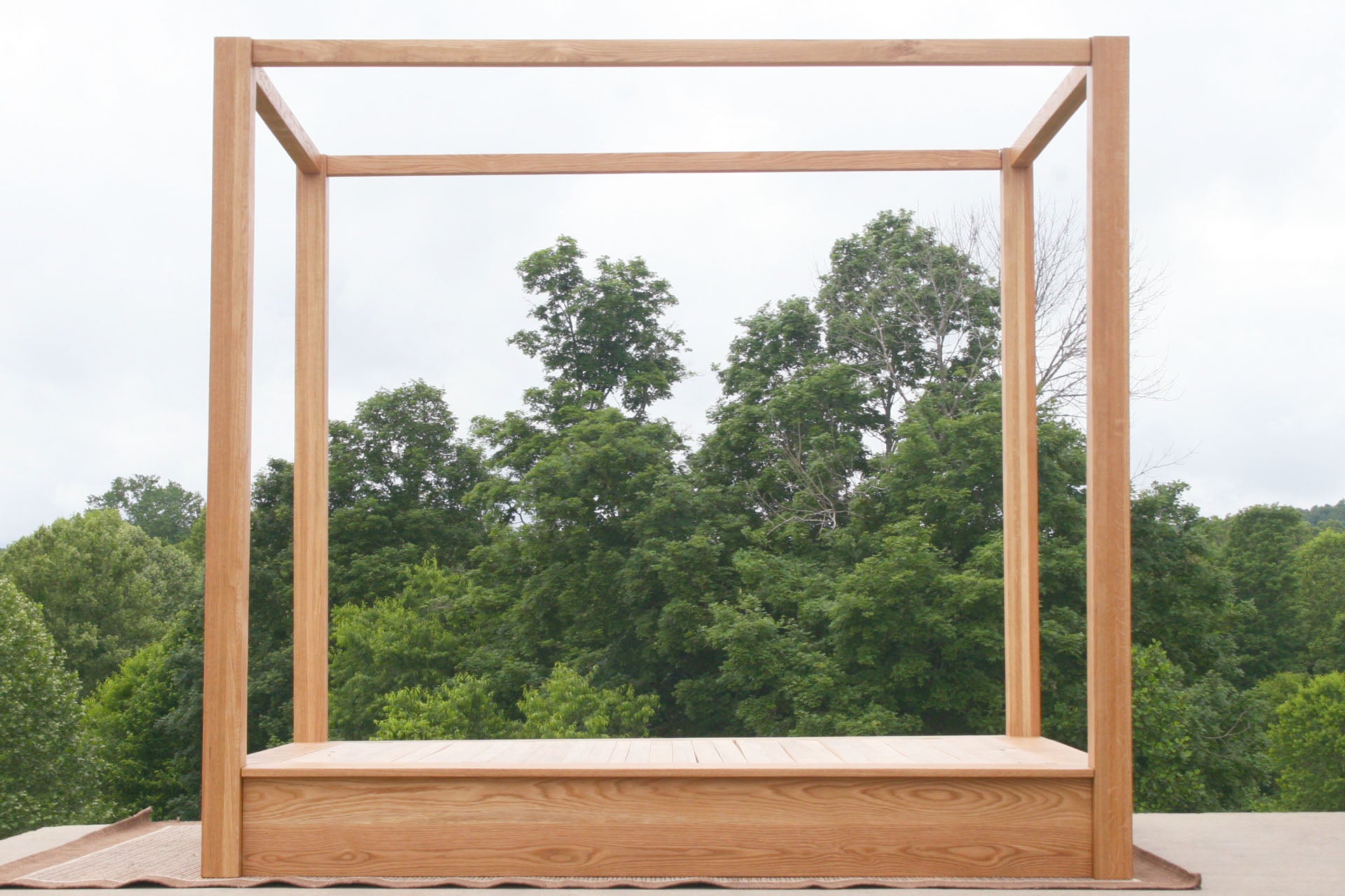 side view Low Platform Bed with large posts and canopy