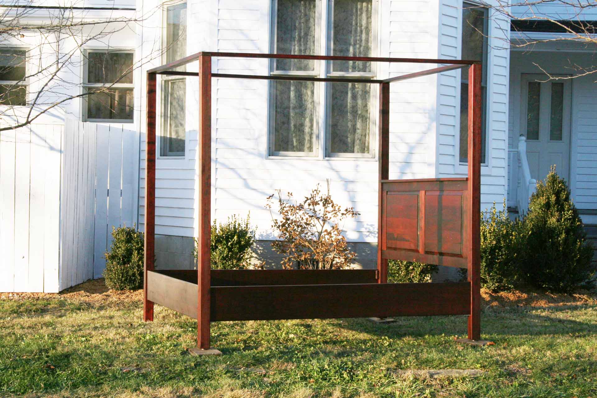 side view hardwood canopy bed with straight posts and paneled headboard