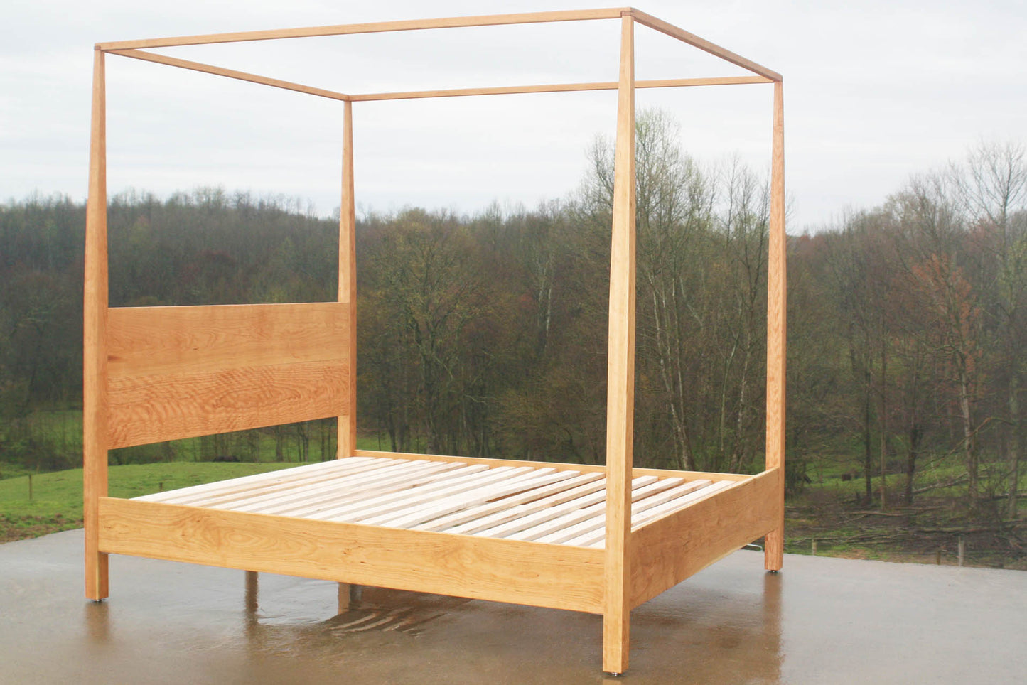 Canopy bed with tapered posts and headboard angled view