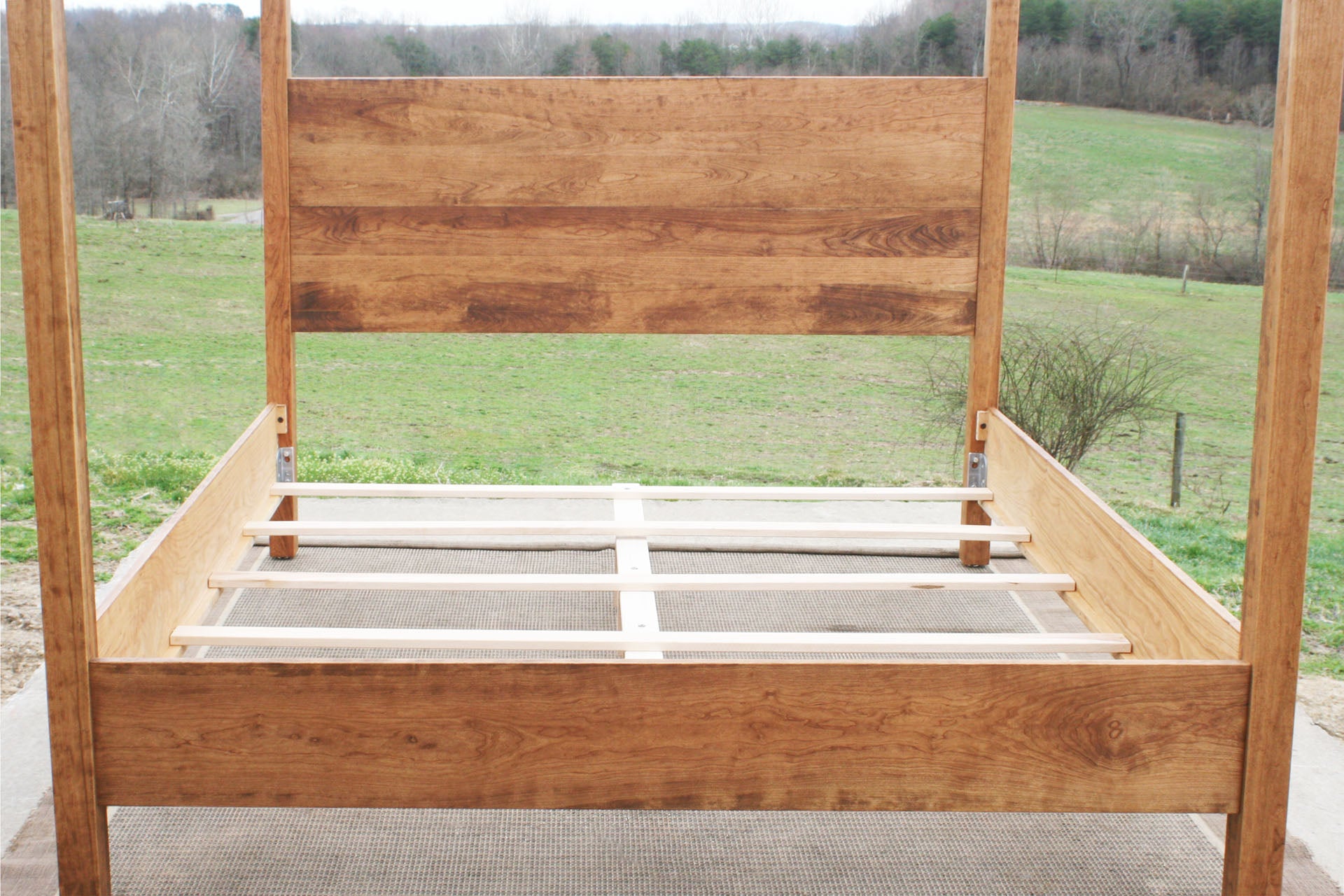 slats of natural Canopy Bed with a square headboard front view
