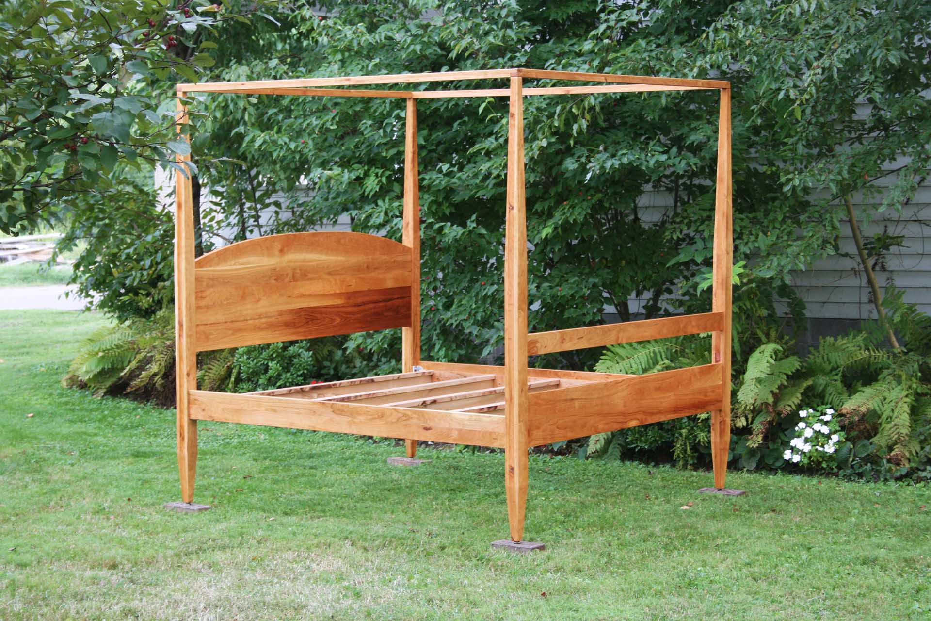 angled view canopy bed with tall legs