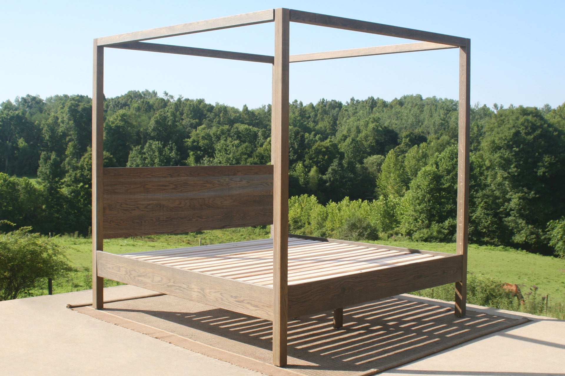 front angled view of solid wood canopy bed with square rails angled view