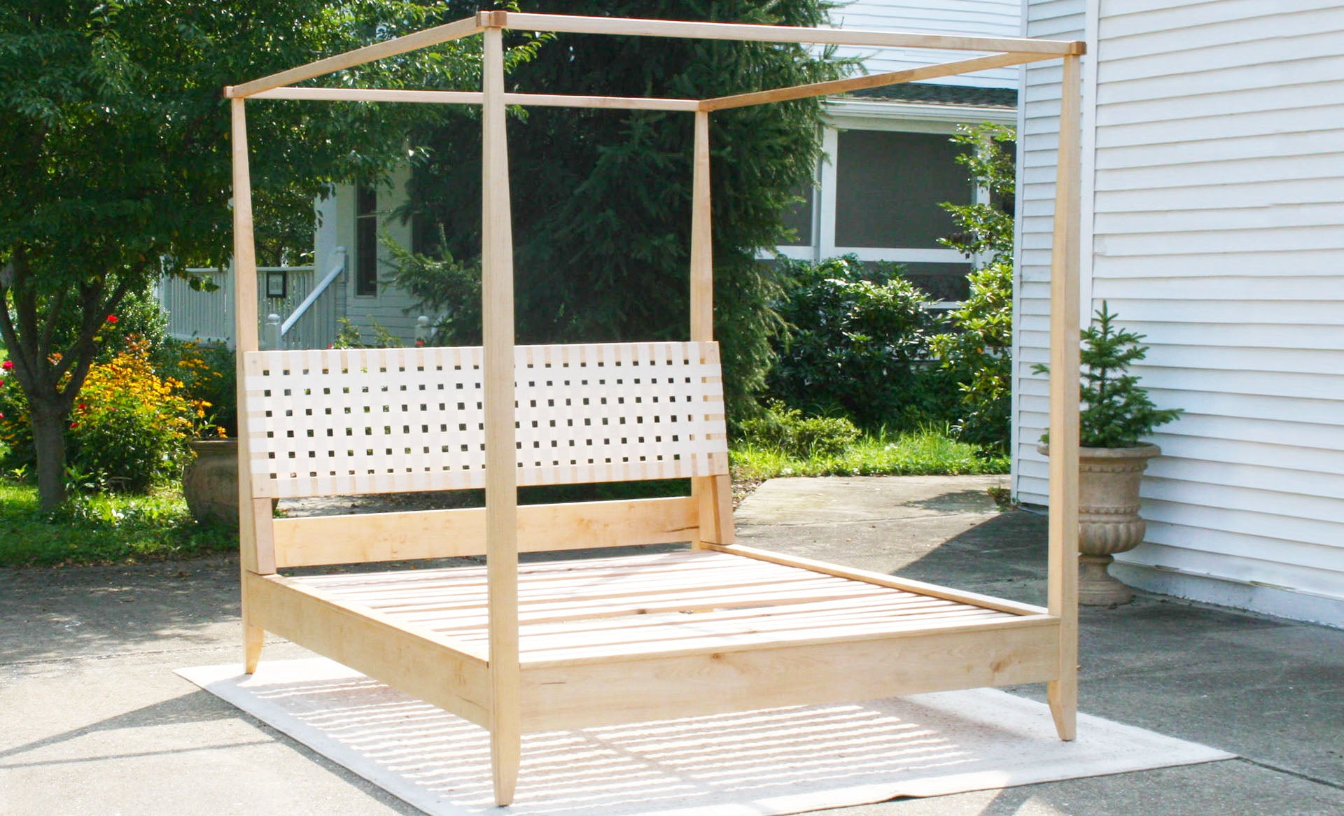 front view solid Canopy bed with woven headboard