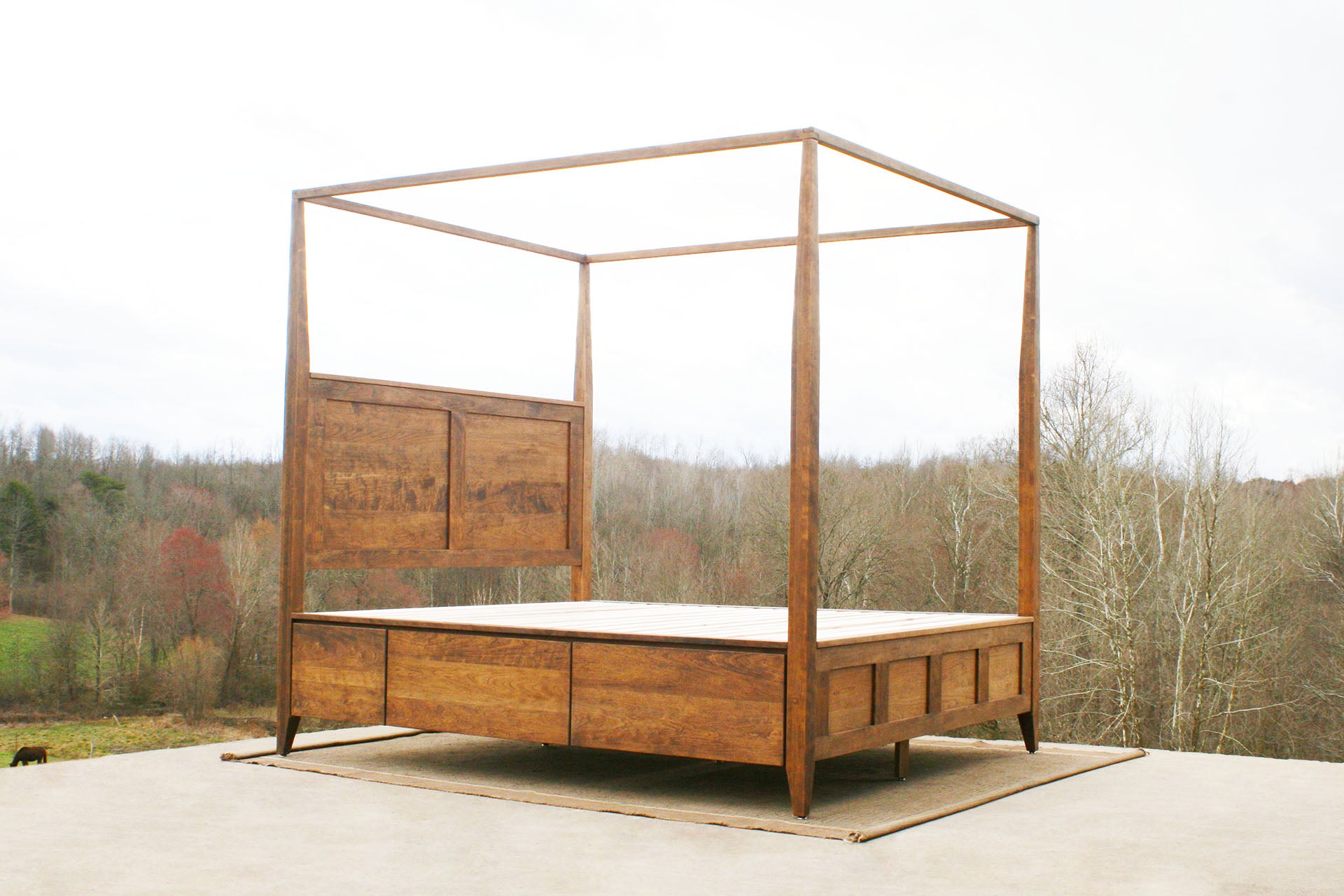 natural hardwood canopy bed with storage side angled view