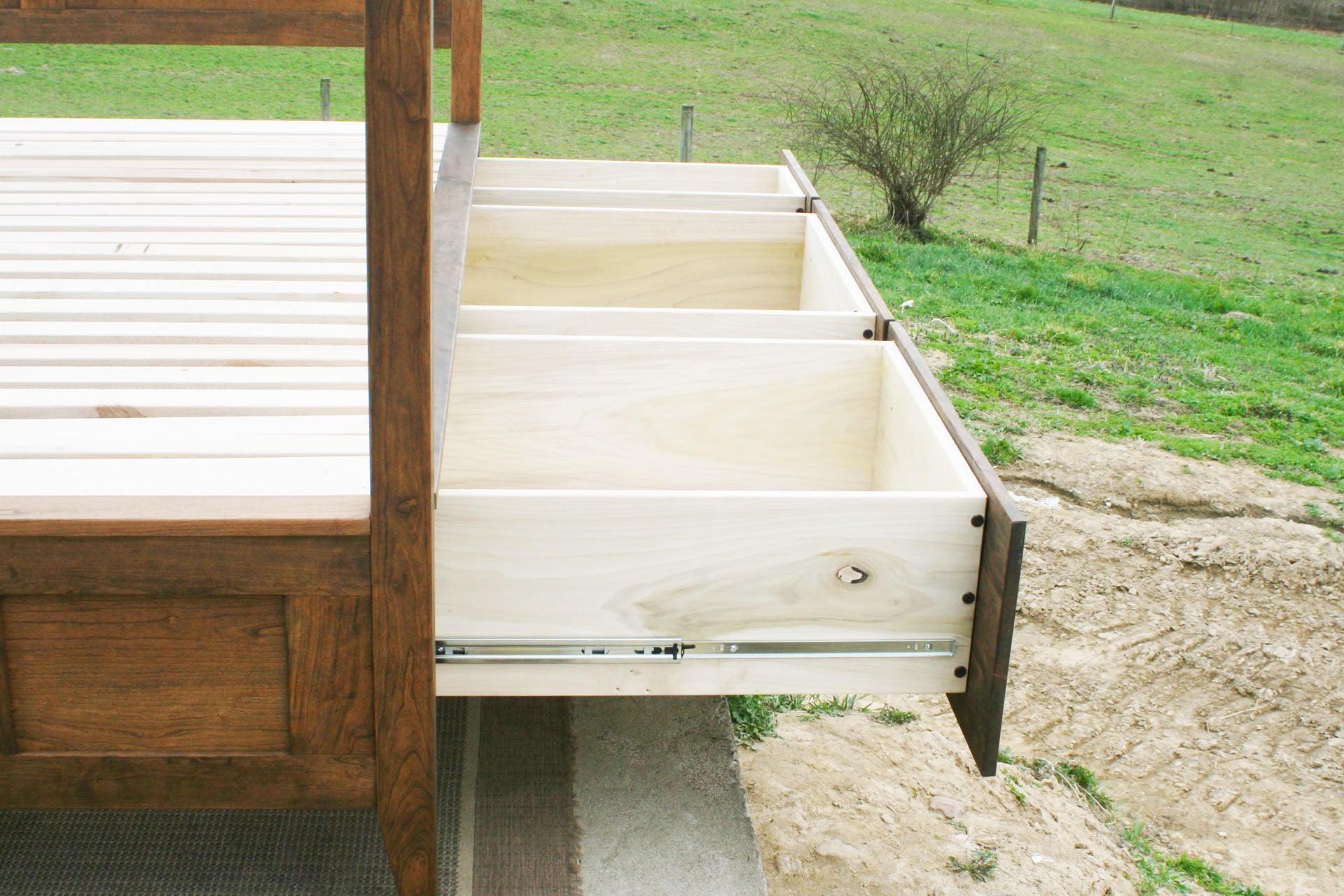 drawers of wood canopy bed with storage