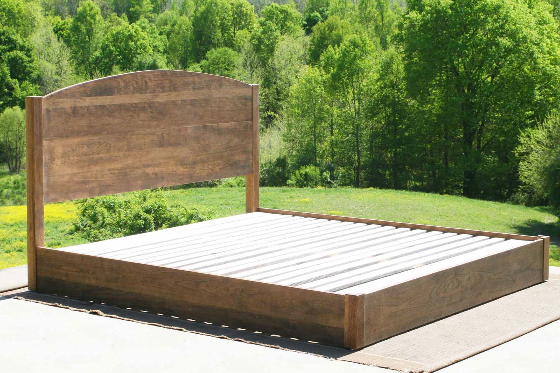 low platform bed with arched headboard side view