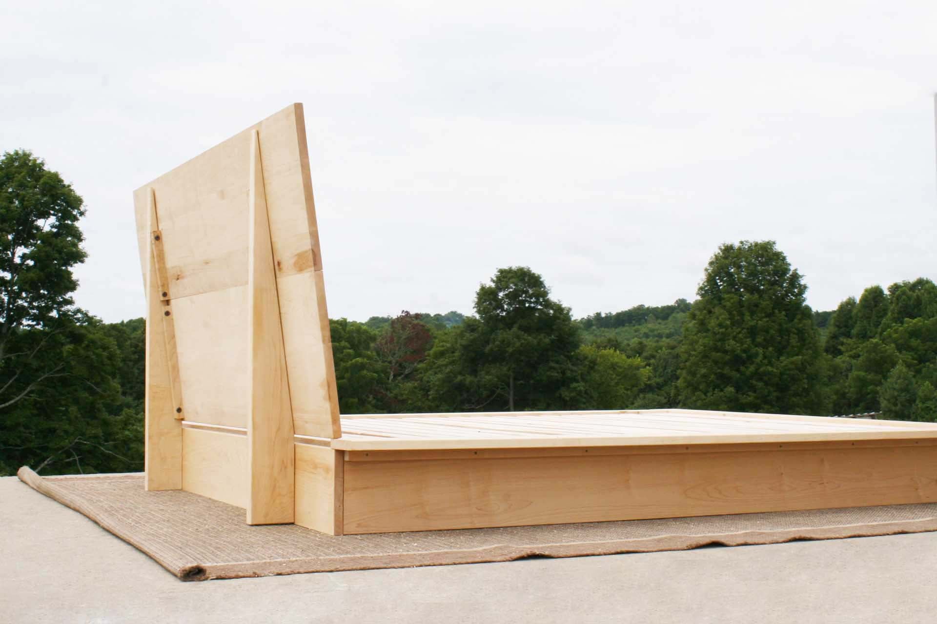 Platform Bed with large headboard and wide platform extensions angled rear view