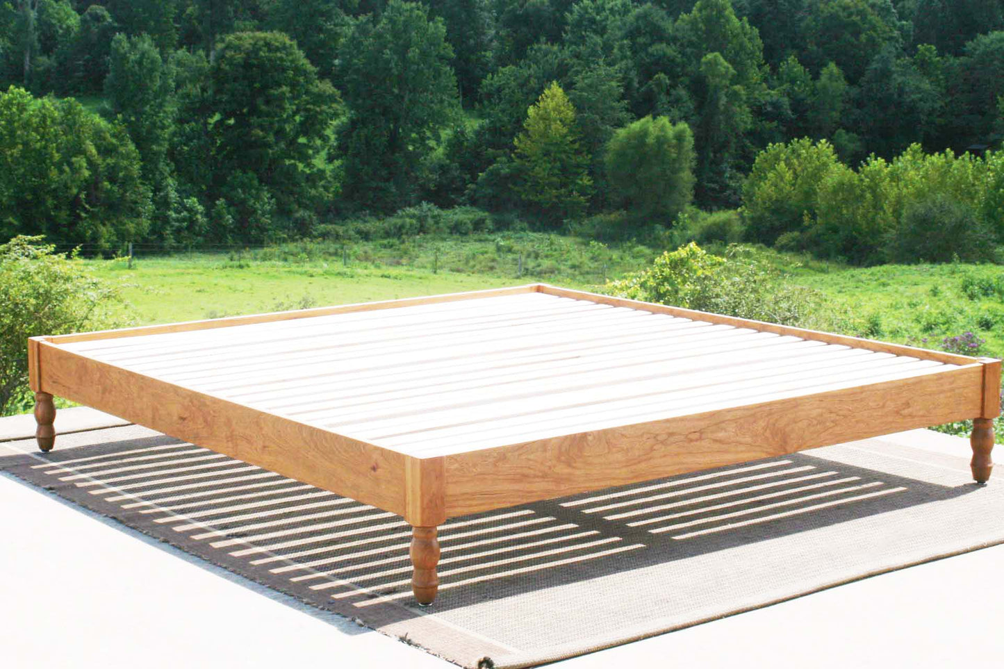 platform bed with turned corner posts angled view