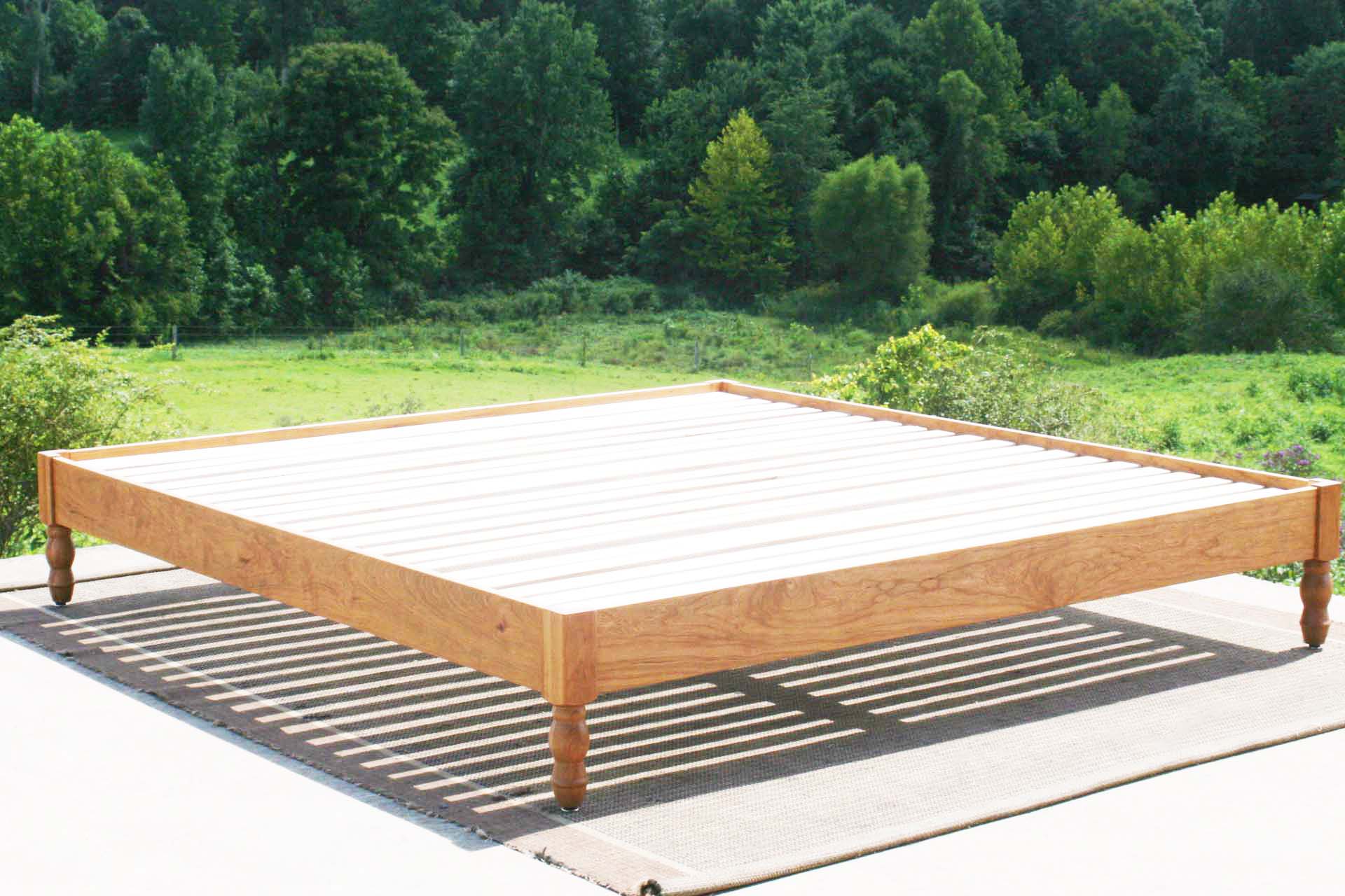 platform bed with turned corner posts angled view