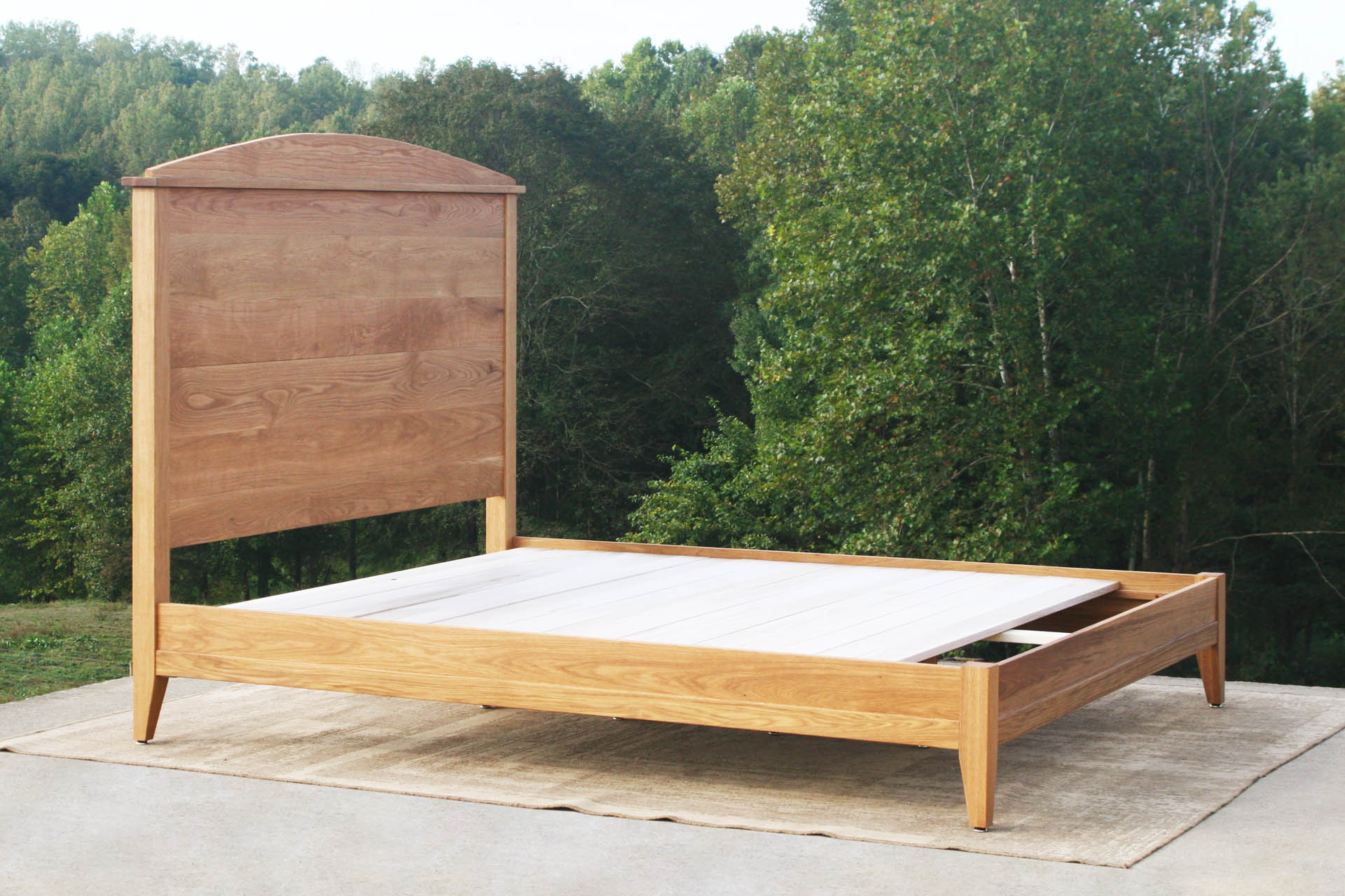 angled view custom Platform bed with tall headboard