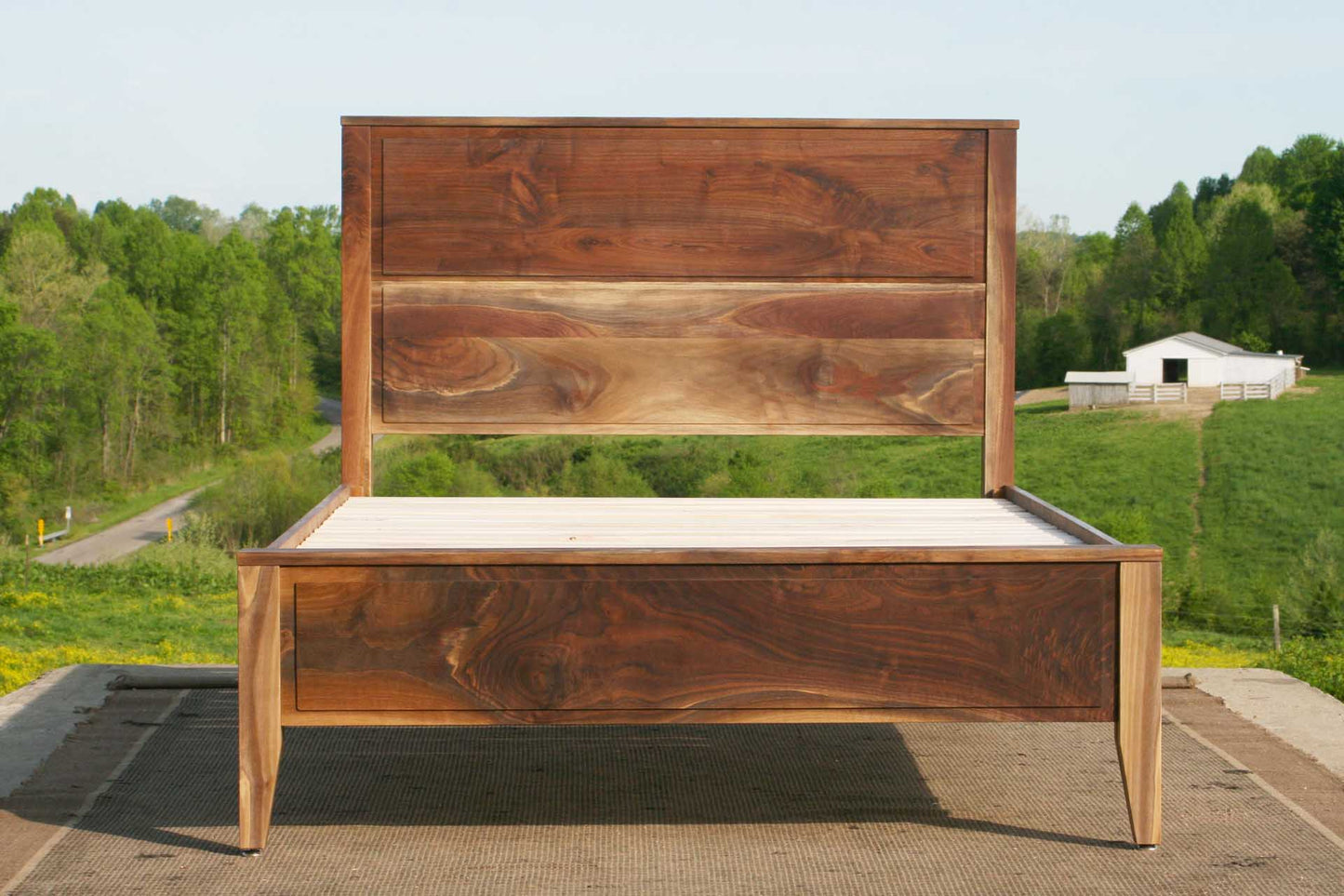 Paneled bed with platform and raised headboard front view