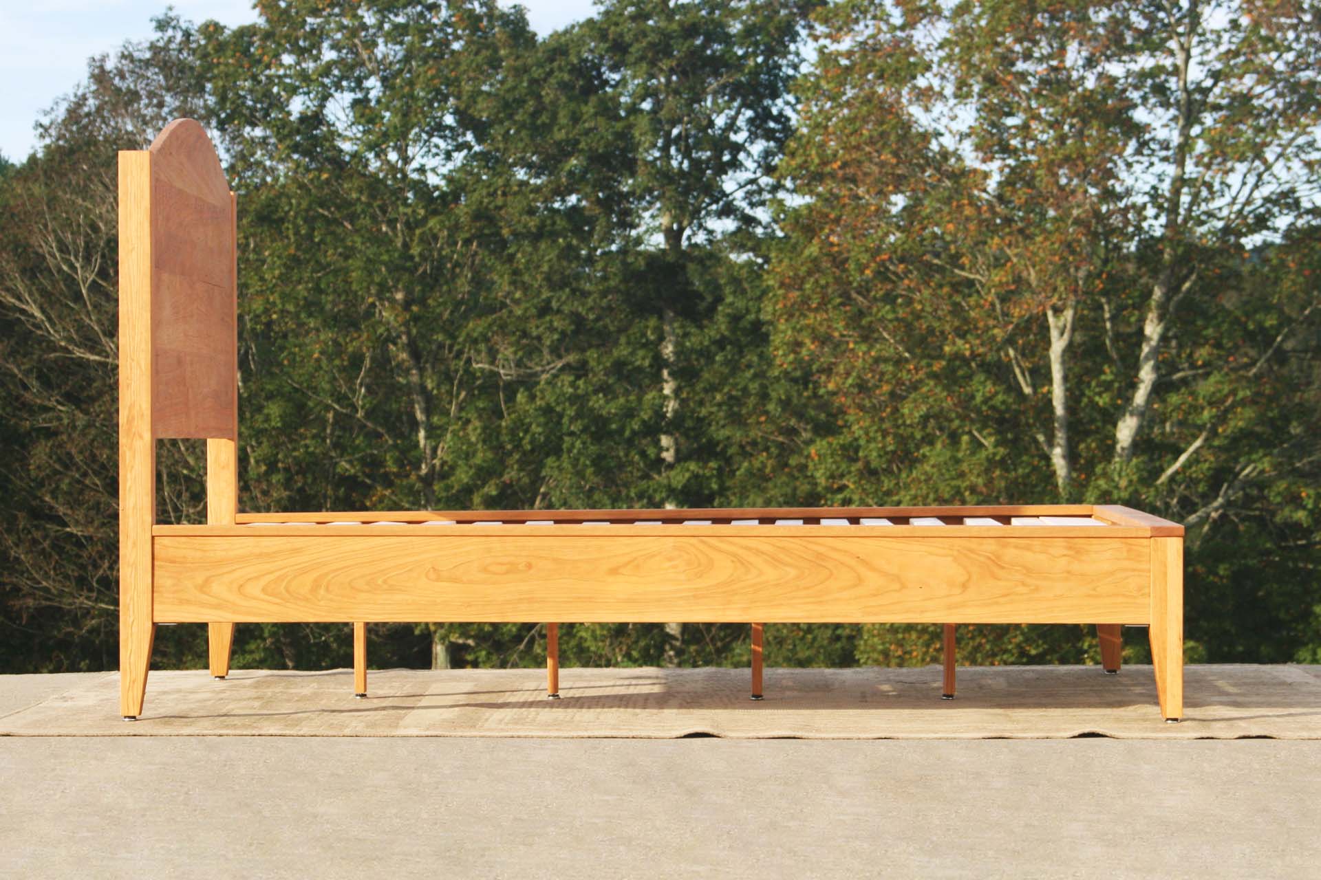 side view natural Platform bed with curved headboard
