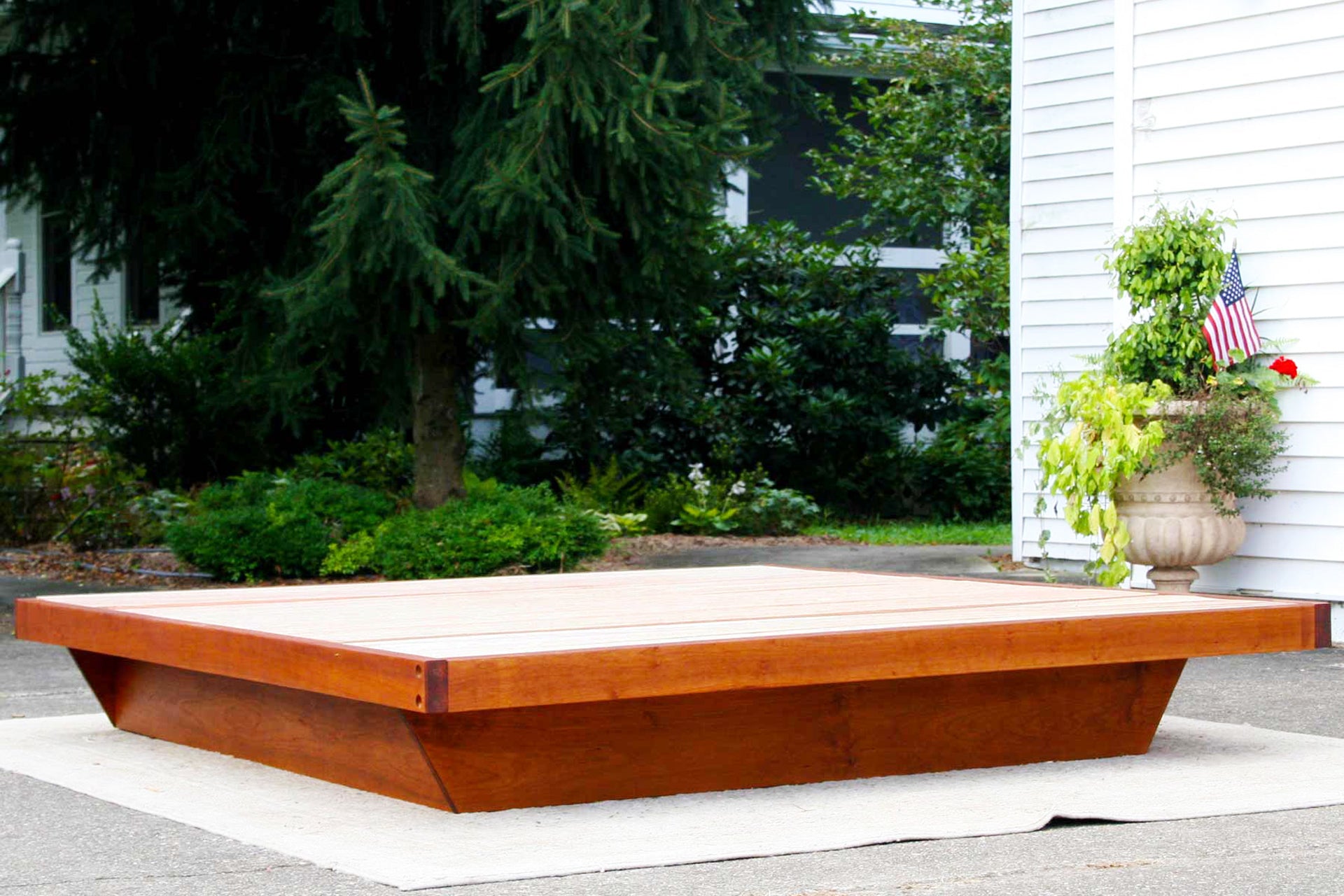 low platform bed frame in cherry wood angle view