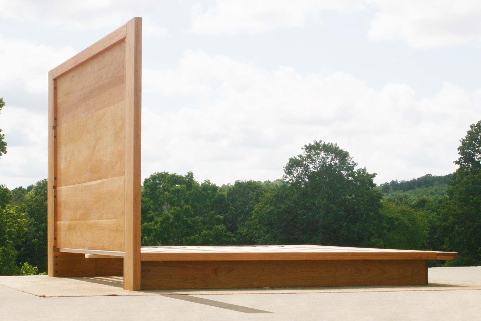 rear view of natural Platform bed with tall headboard