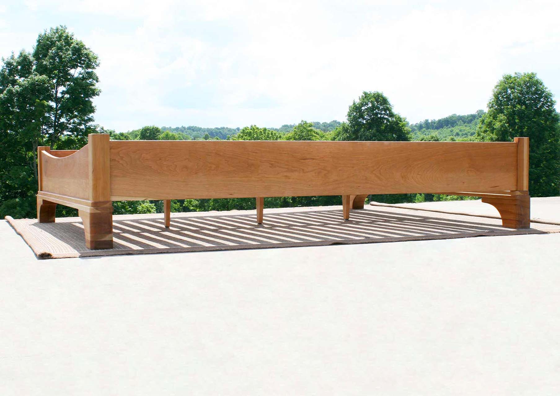 side view Platform Bed with large block feet and arched ends