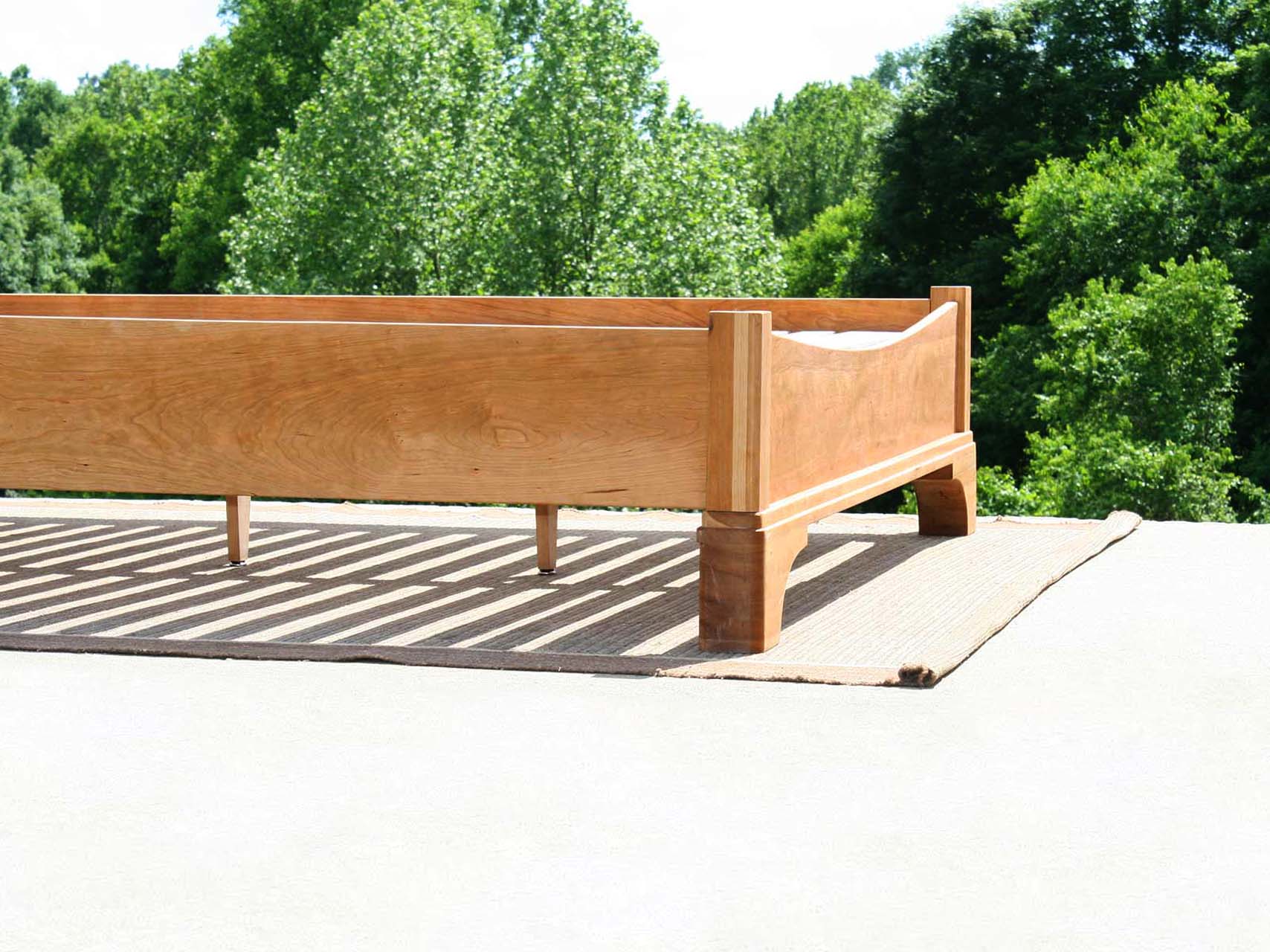 end of Platform Bed with large block feet and arched ends low view