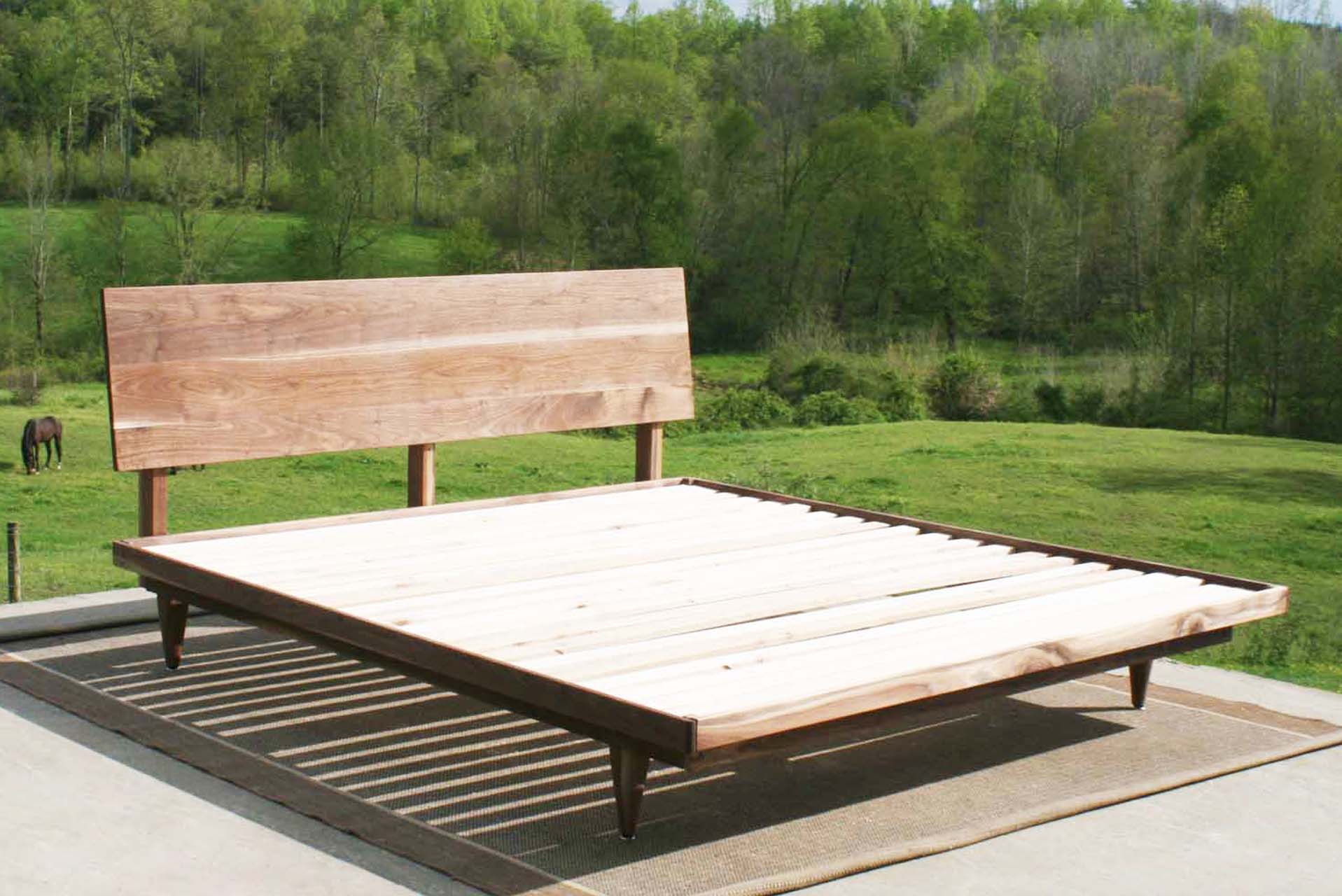 angled view walnut mid century platform bed