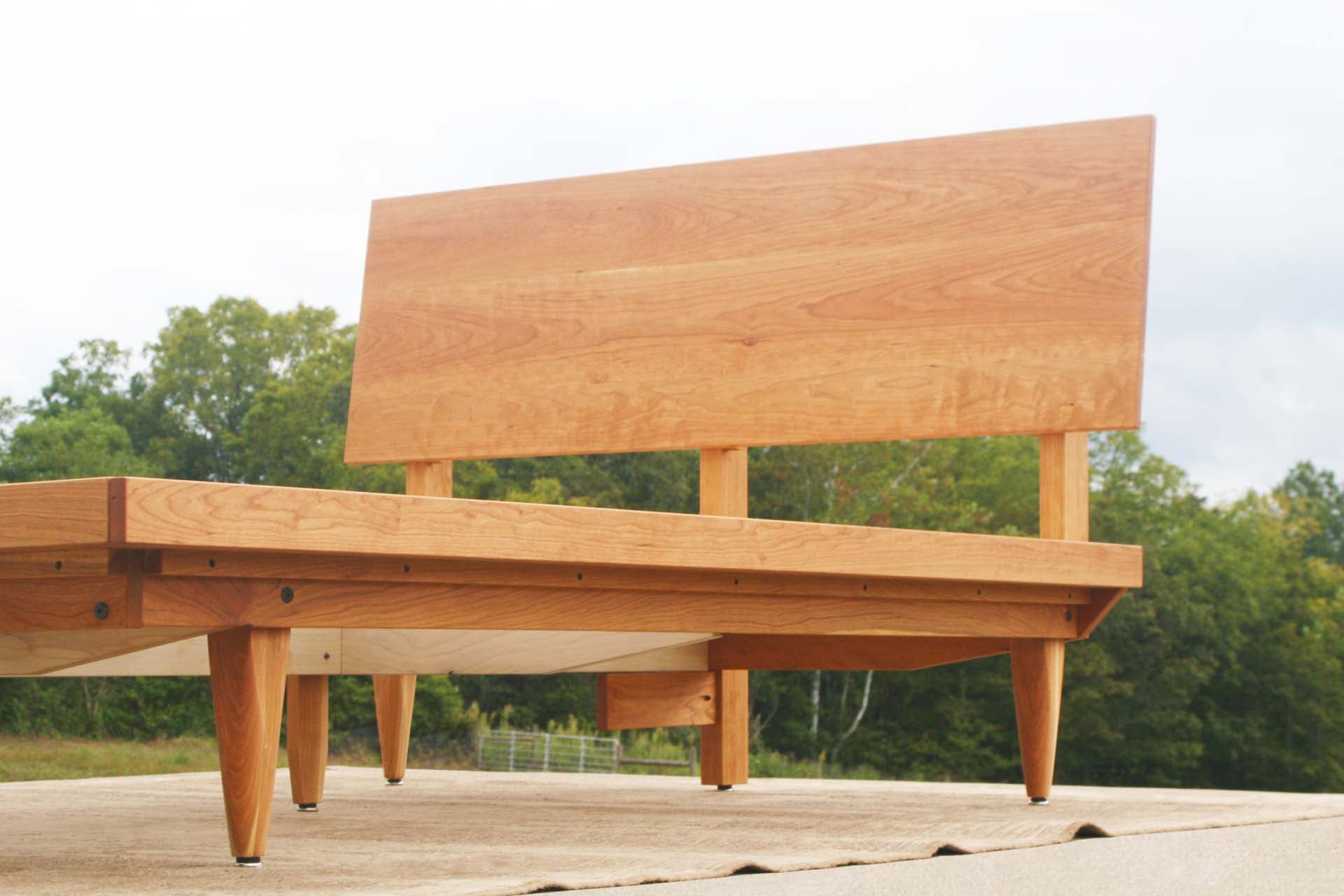 low angled view natural Mid Century Platform Bed with Slanted Headboard