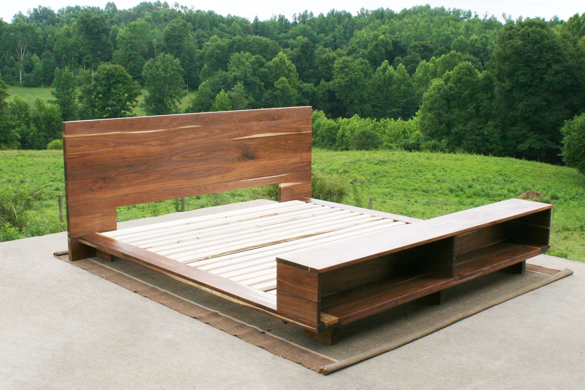 angled view natural Low platform bed with bookcase foot-end