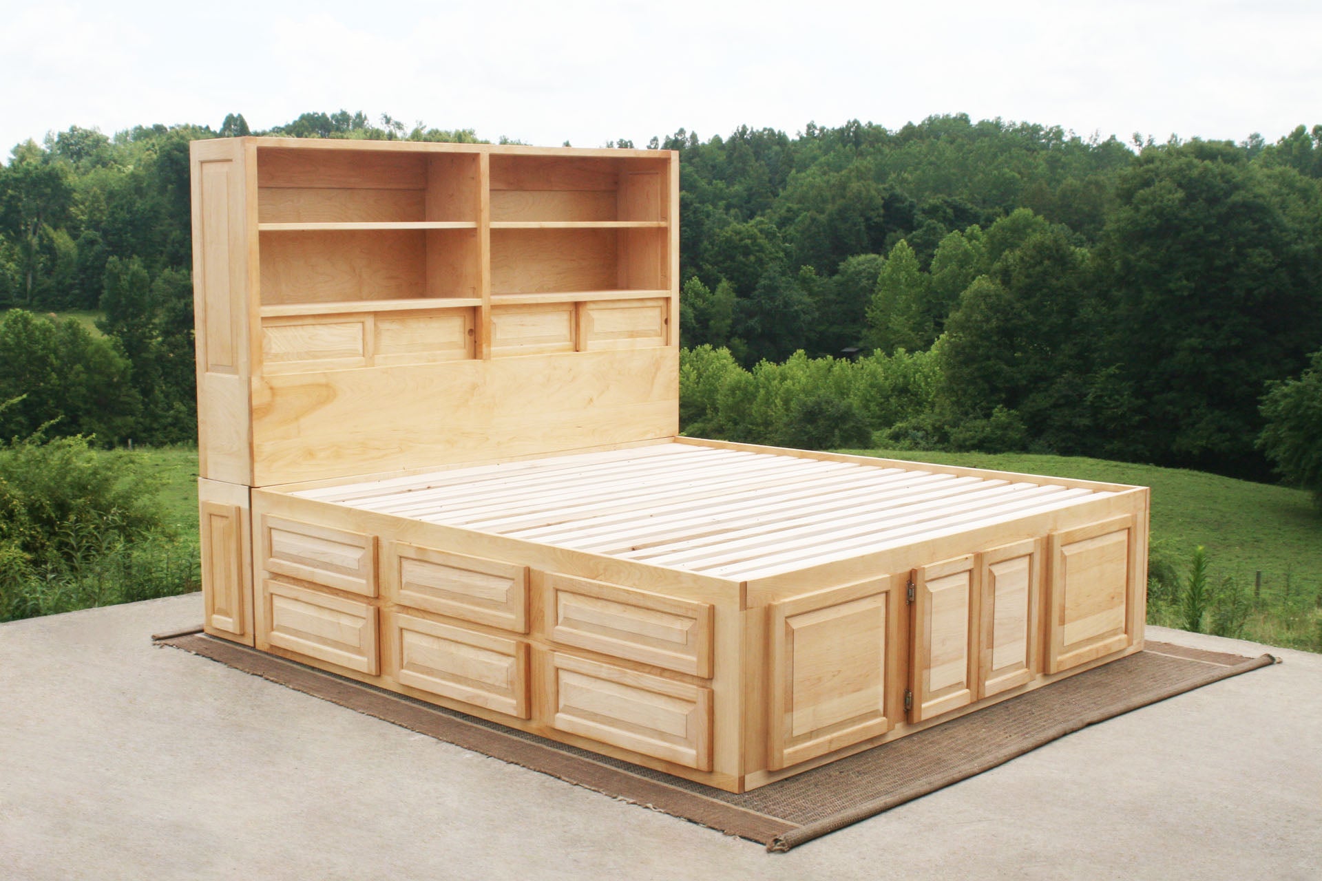 angled view of 12 drawer captain's bed with storage headboard