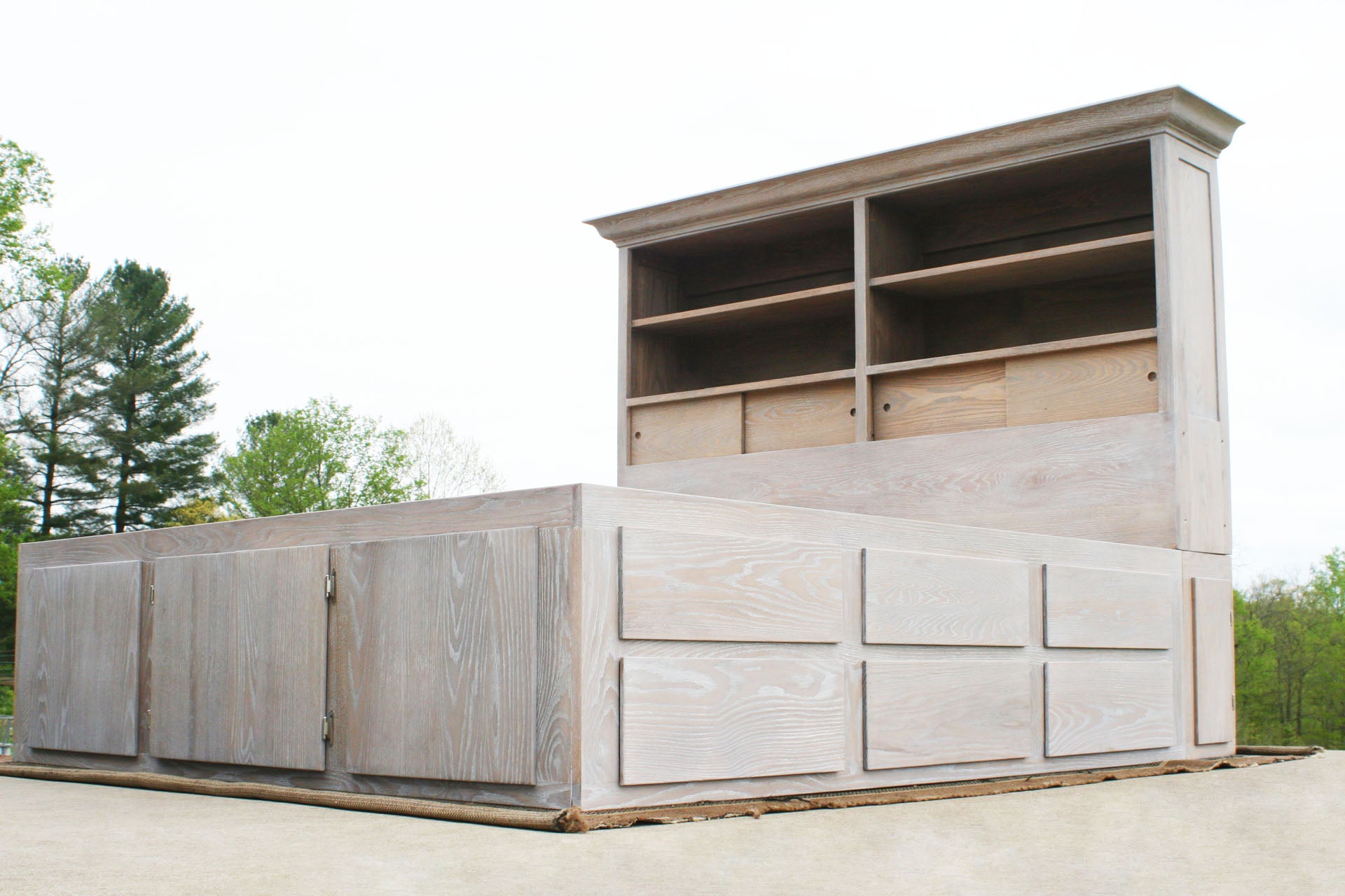 low angled view wood 12 drawer captain's bed with storage headboard