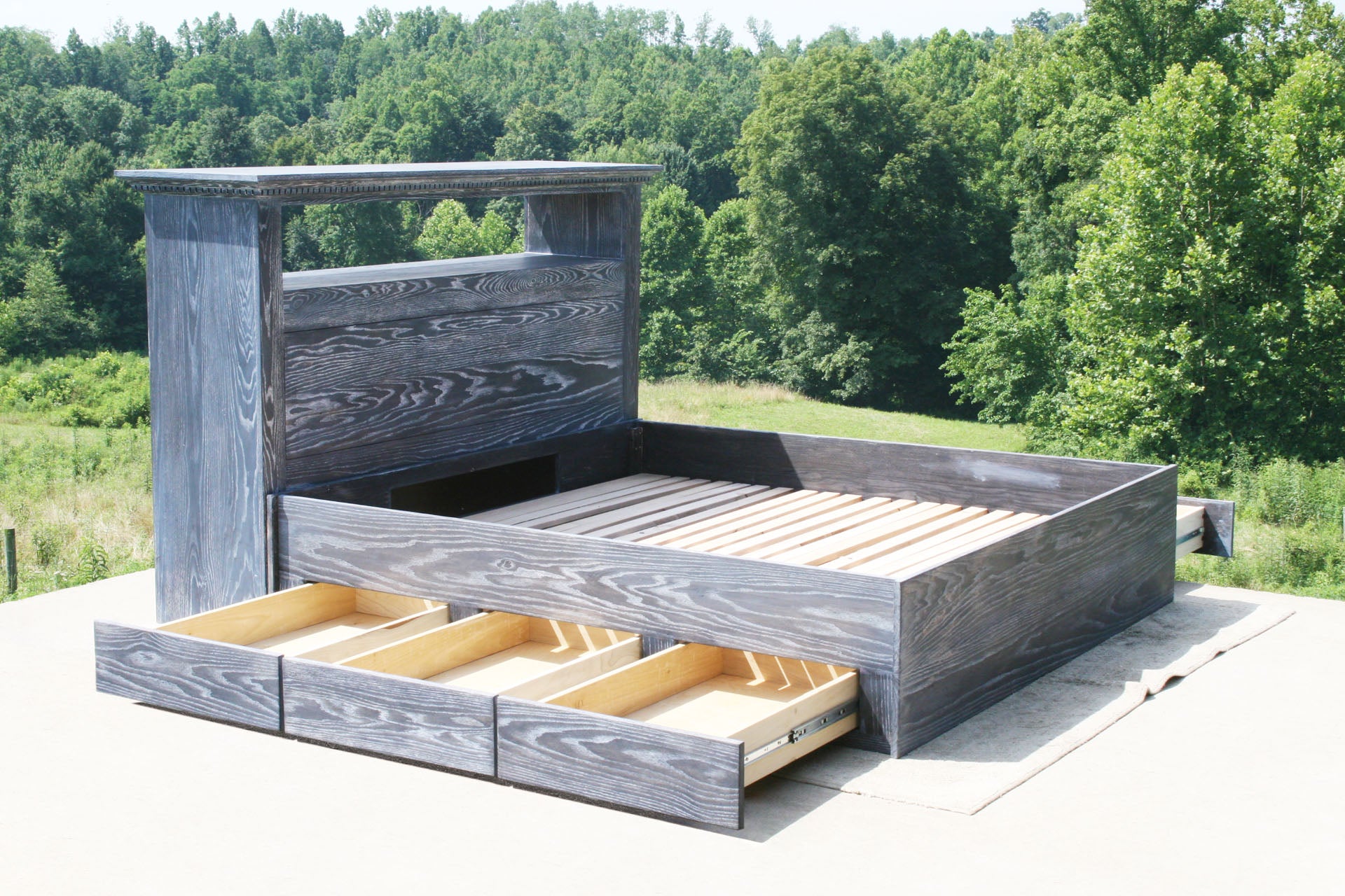 side angled view Platform bed with 6 drawers and storage headboard with drawers open