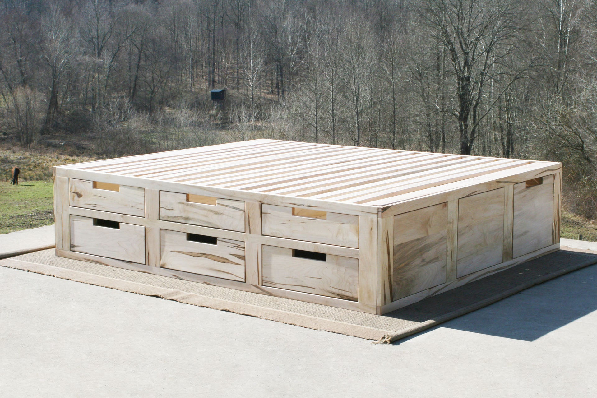 natural wood Mates bed with 6 drawers on 1 side