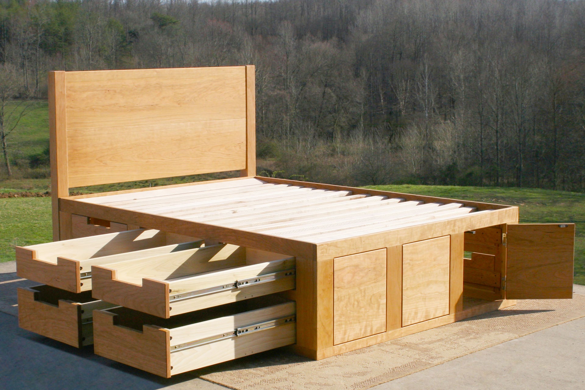 wood angled view Mates bed with 6 drawers 4 drawers open on 1 side