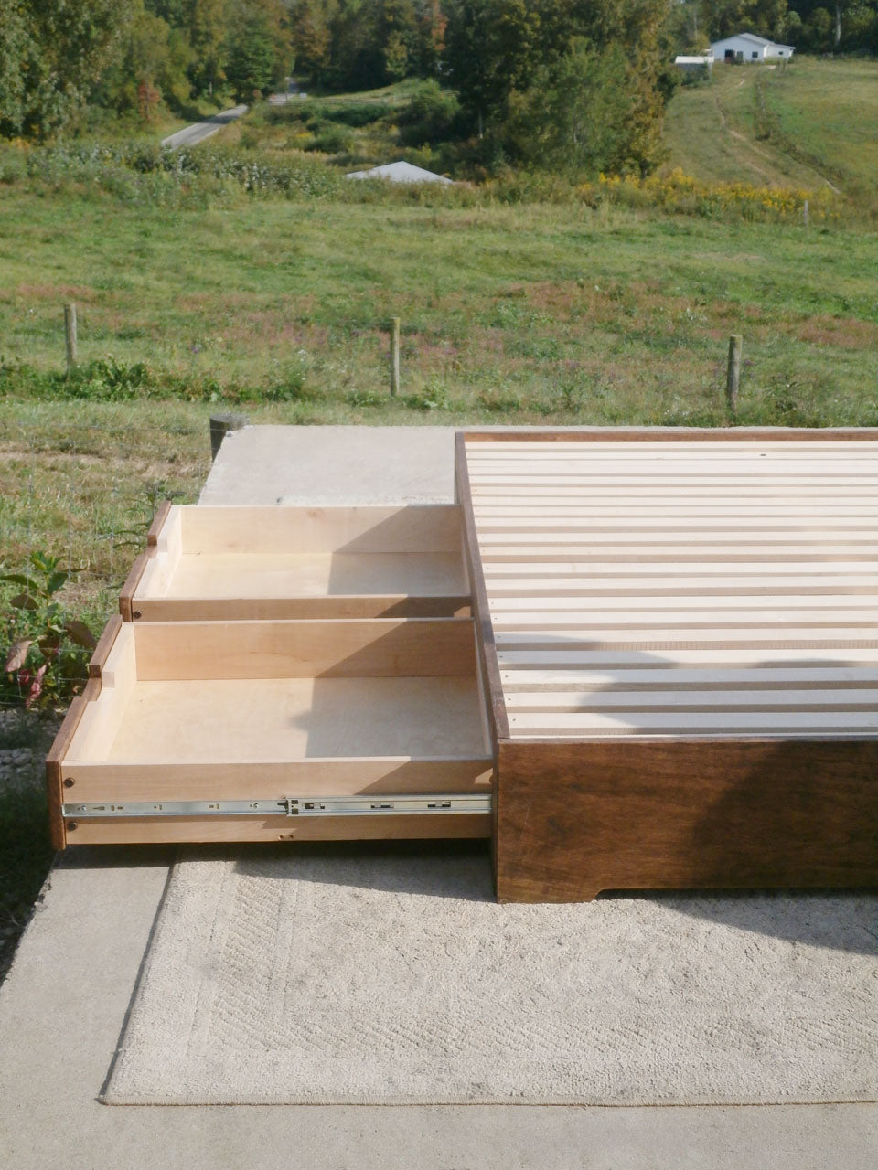 Low profile storage bed with 4 drawers 2 drawers open
