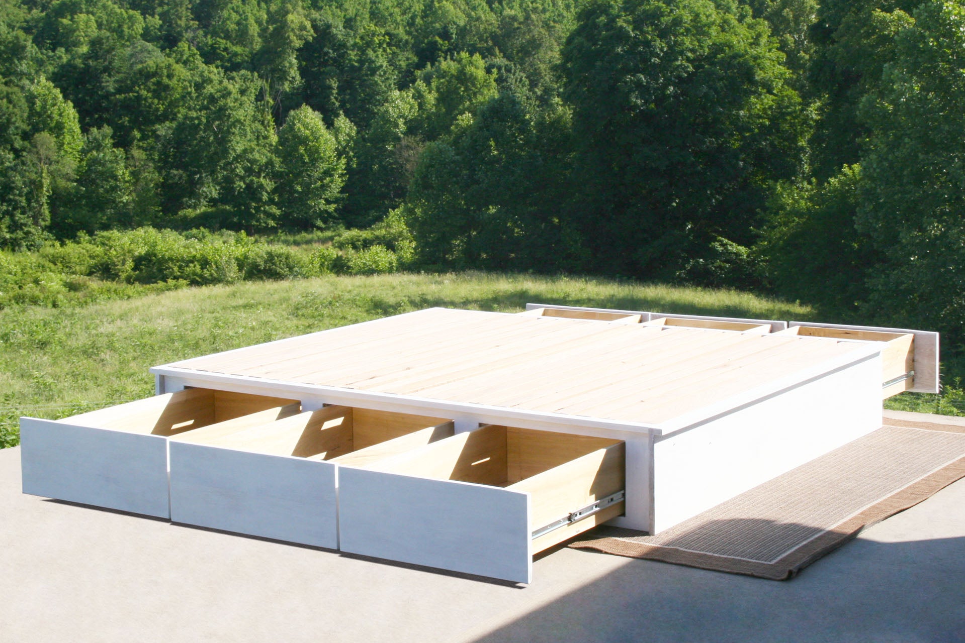 side view 6 Drawer Storage Bed with flat platform with drawers out natural stain
