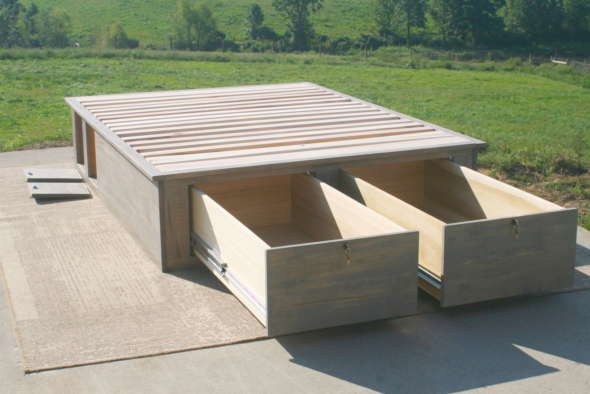 platform bed with front drawers open 3 quarter view