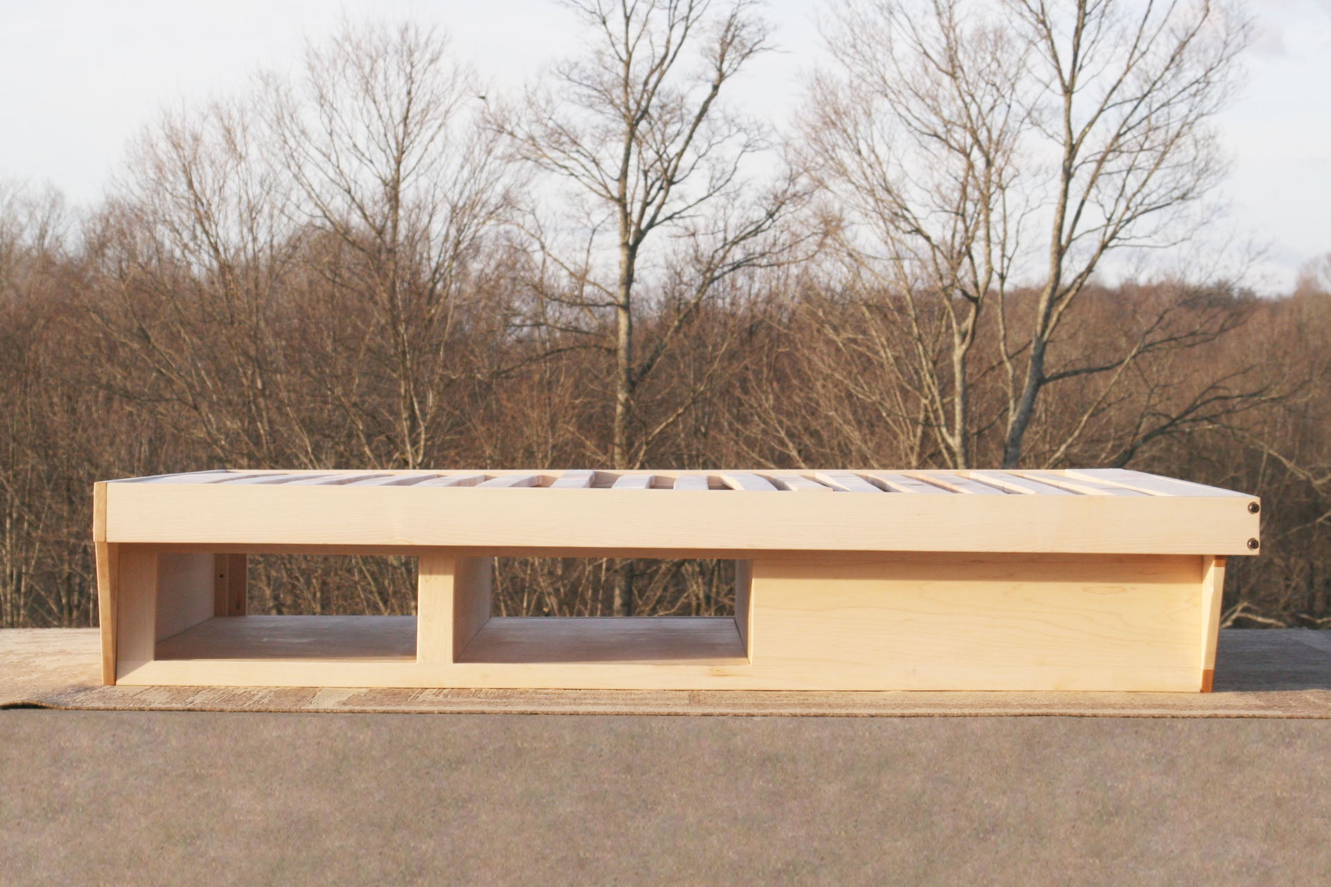 natural side view low Platform Bed with angled base and 2 drawers