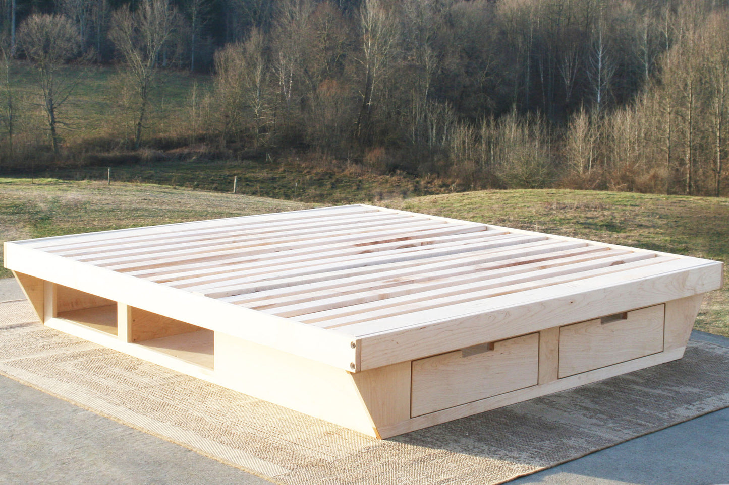 angled view natural low Platform Bed with angled base and 2 drawers