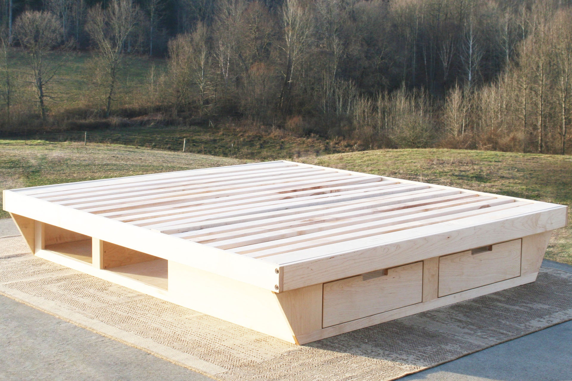 angled view natural low Platform Bed with angled base and 2 drawers