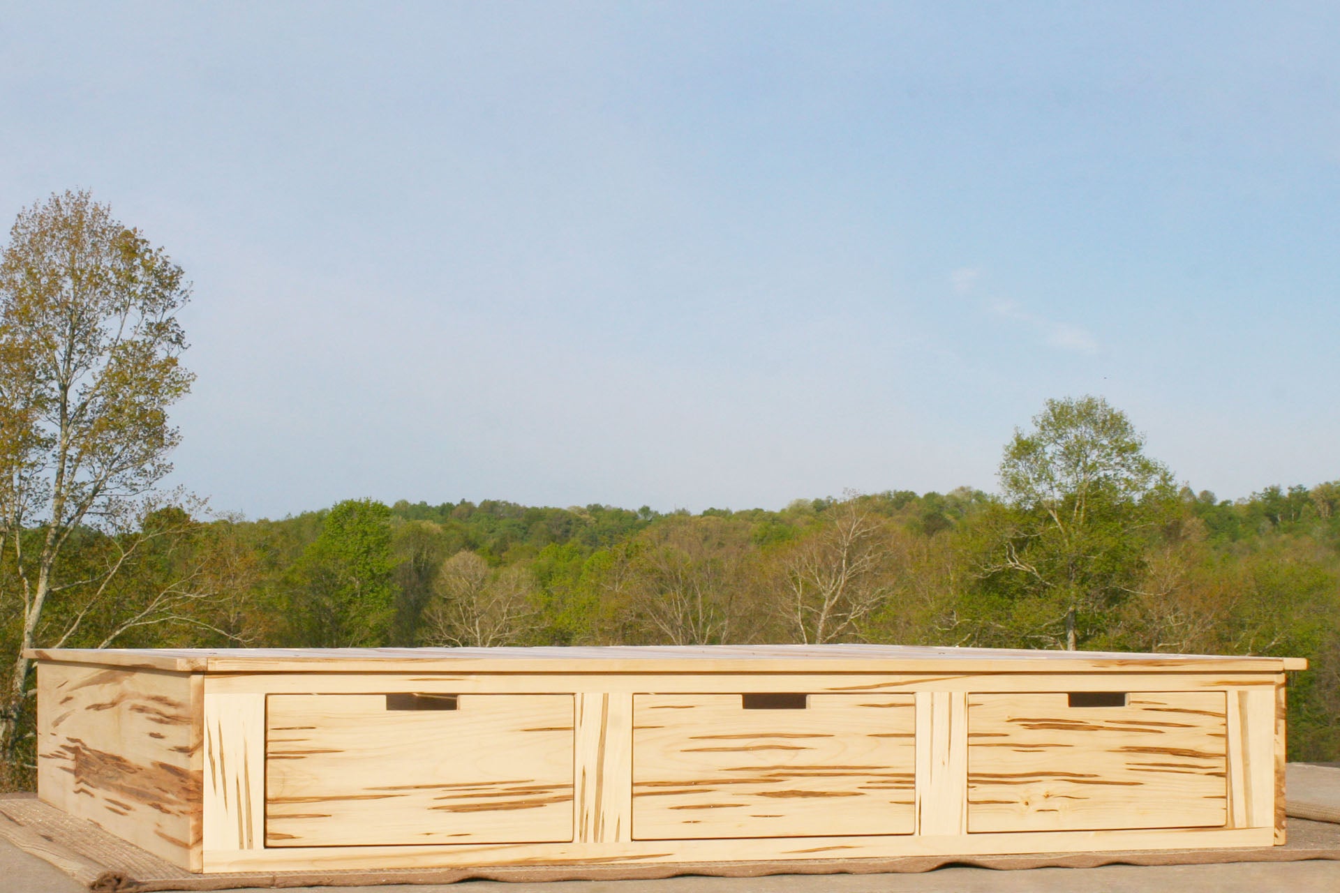 Platform storage bed wormy maple low side view