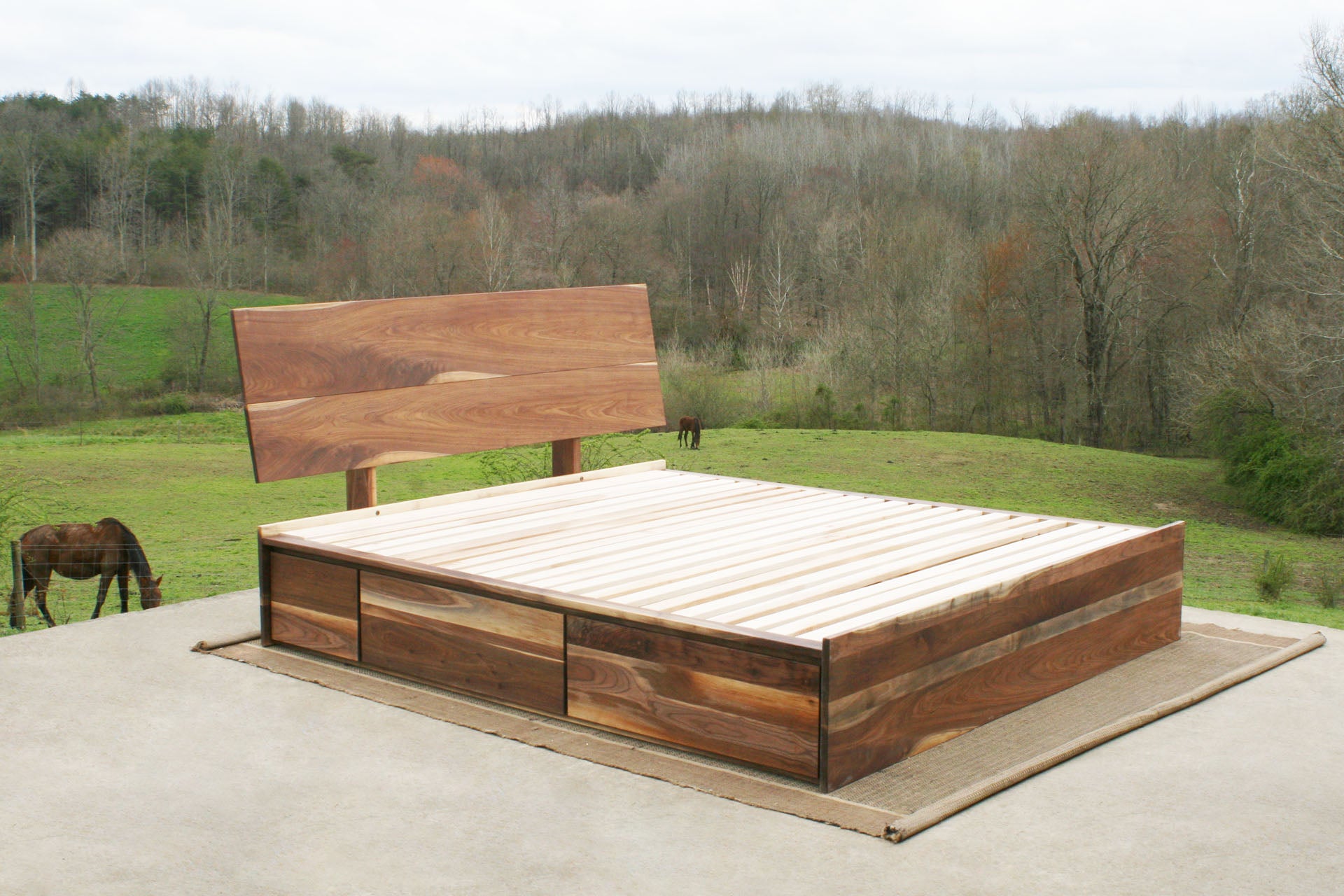 angled view walnut Low Storage Bed with 6 drawers and angled headboard