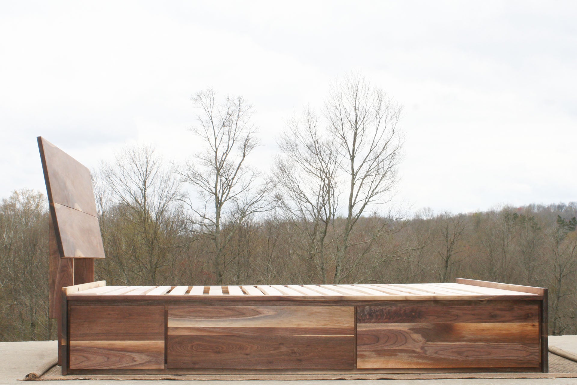 side view walnut Low Storage Bed with 6 drawers and angled headboard