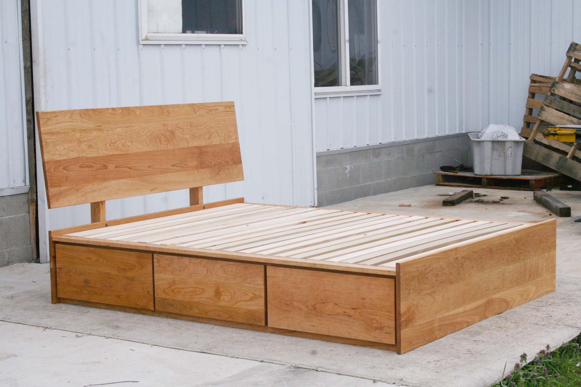 angled view natural Low Storage Bed with 6 drawers and angled headboard